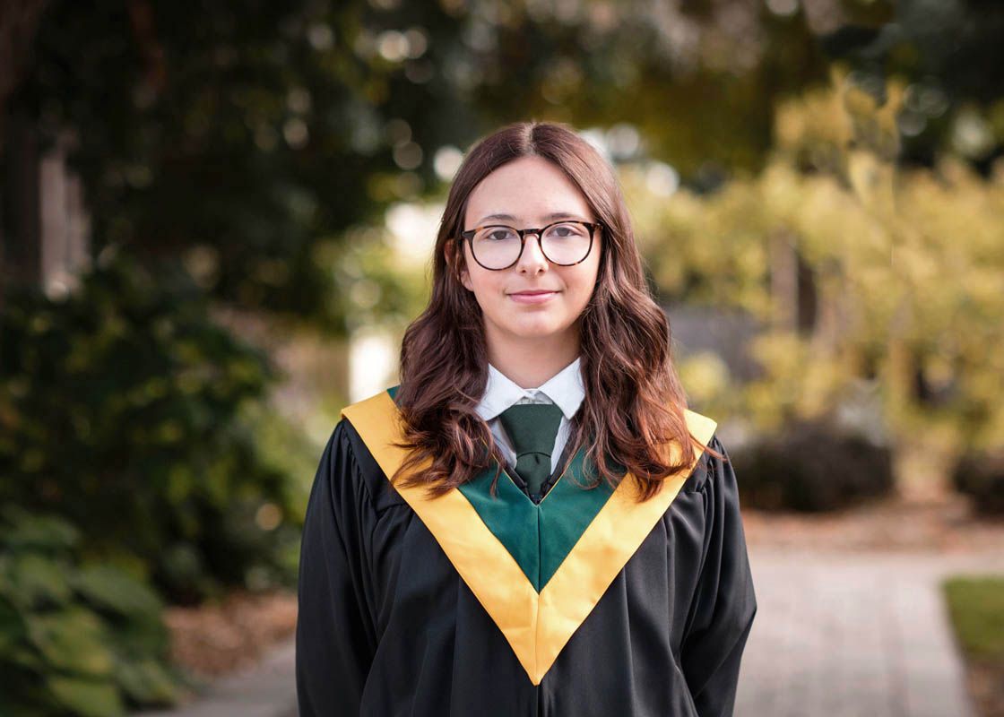 School portraits showing students in black and gold academic uniforms in an outdoor setting.