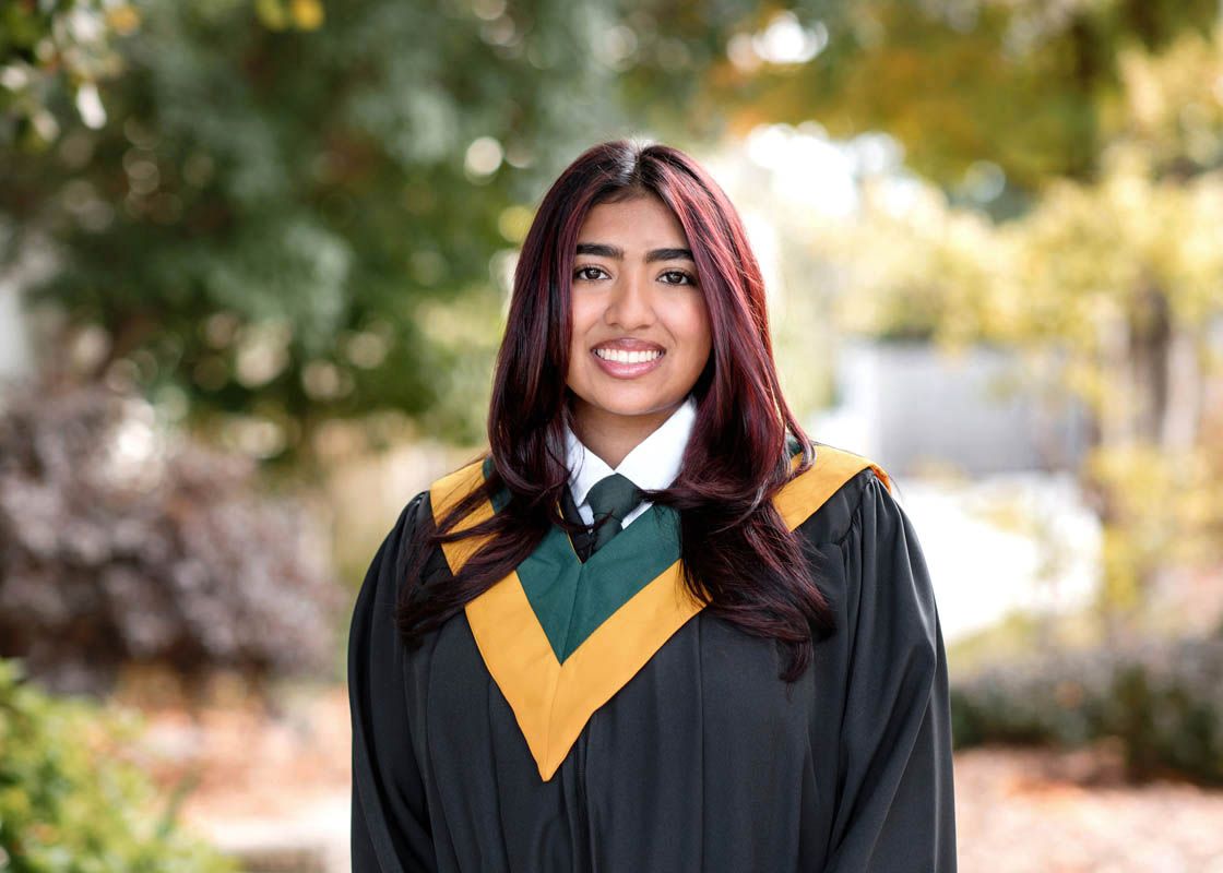 Multiple graduation portrait shots outdoors with yellow stoles and black gowns.