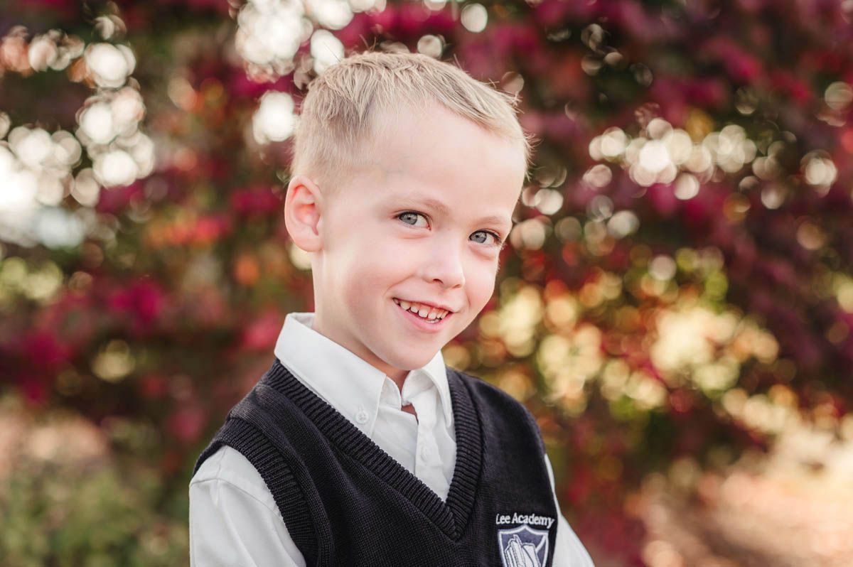 Series of school photos showing students in black vests and white shirts against red leaves.