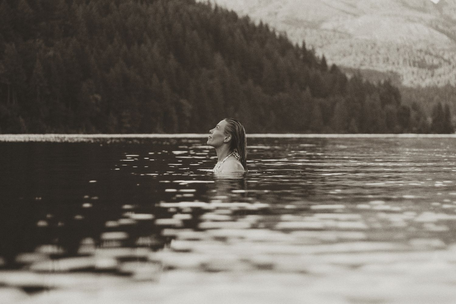 Scenic mountain lake view with evergreen forest along the shoreline.