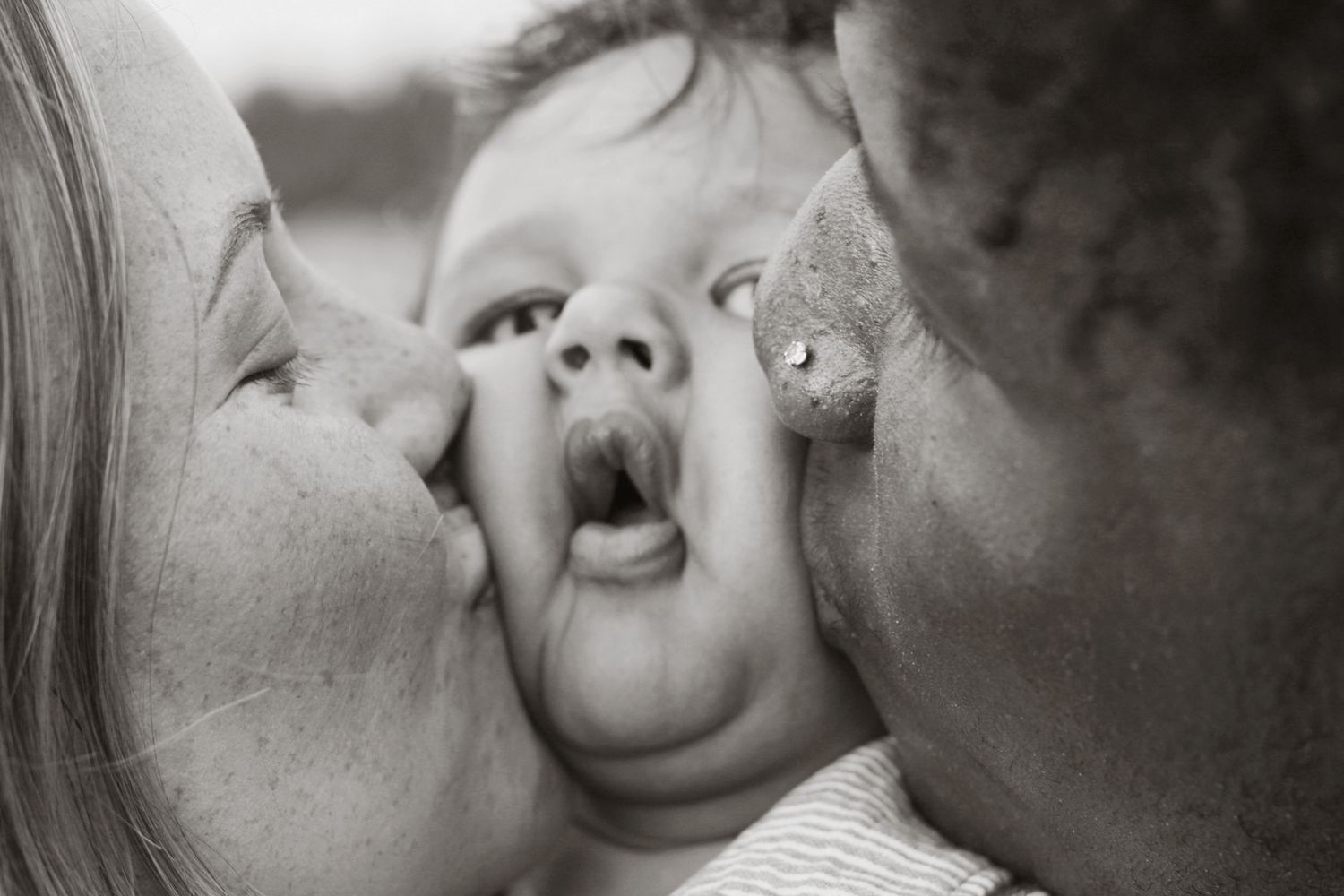 Black and white intimate close-up photo showing affectionate moments.