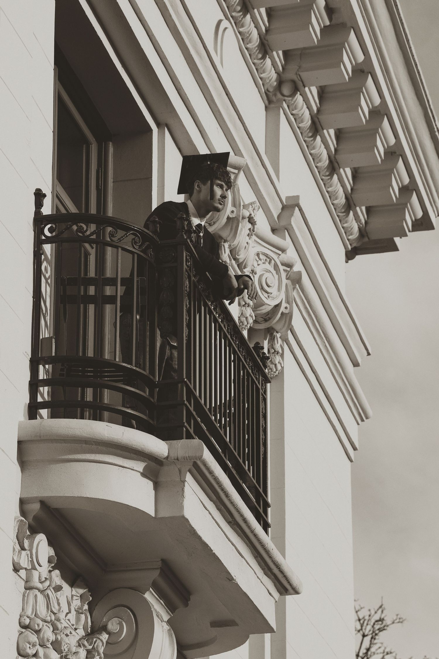 Ornate white architectural details with decorative corbels and balconies on a classic building facade.