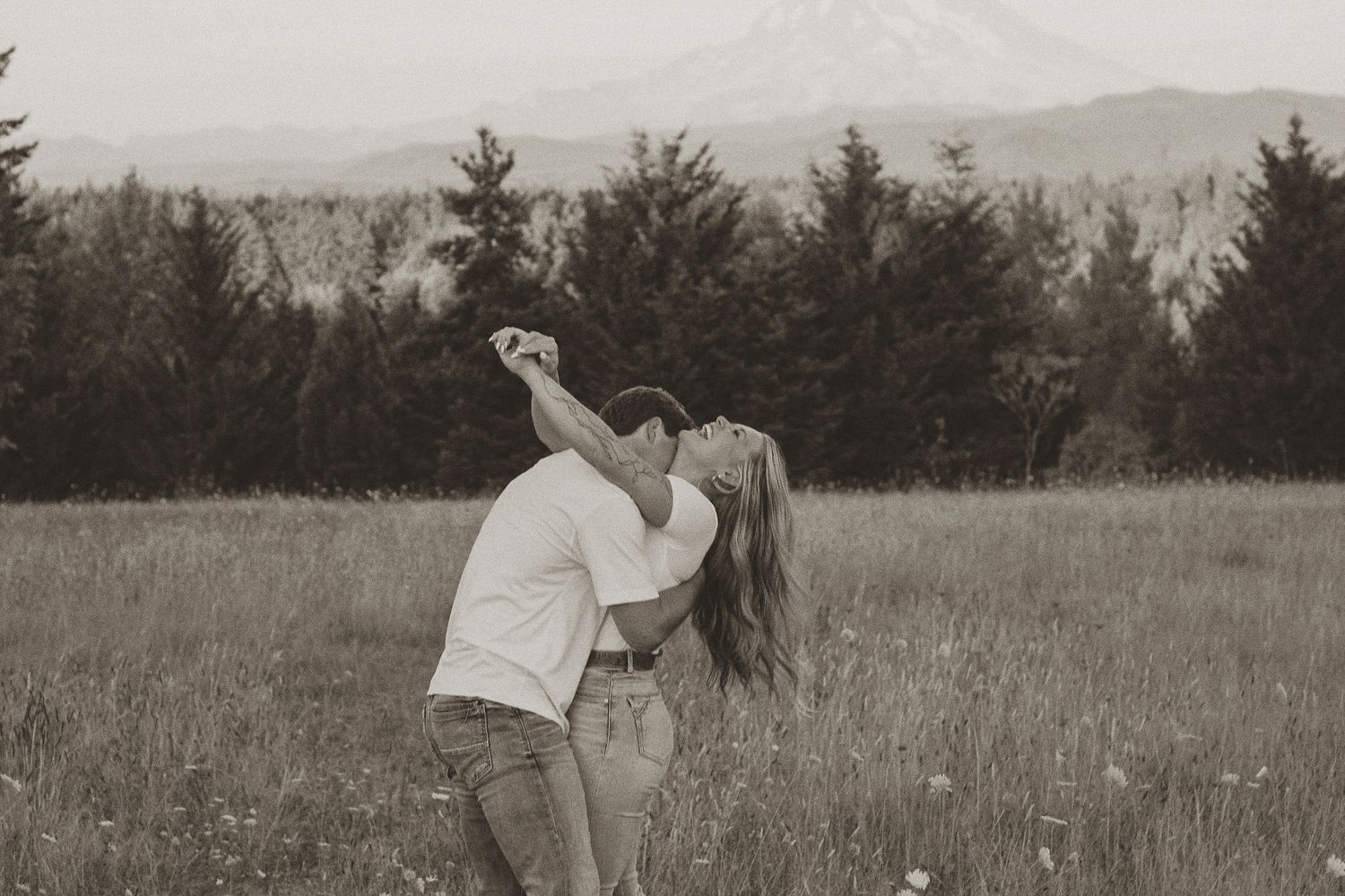 A series of vintage black and white photographs showing people in a field with mountains in the background.