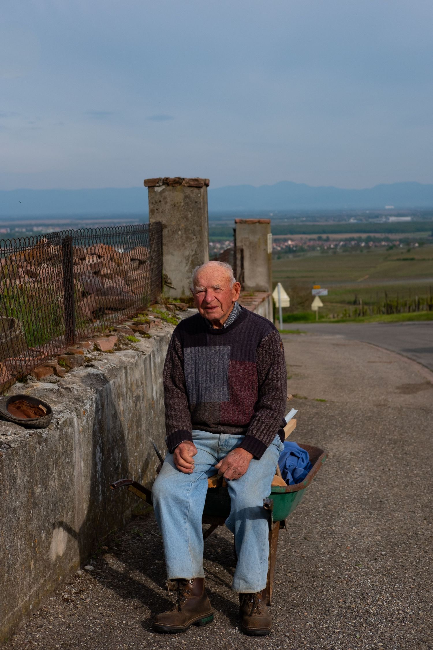 Stone wall overlook with benches providing panoramic views of distant mountains and countryside.