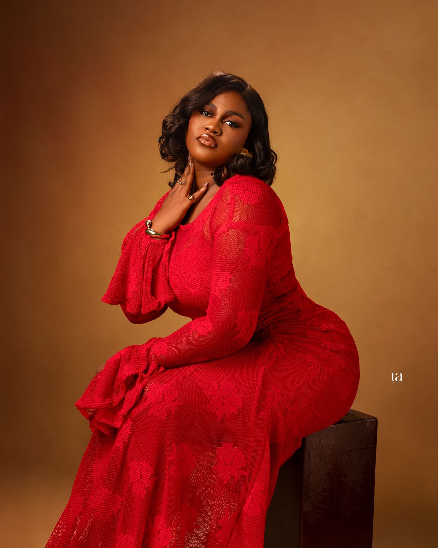 Fashion photography series showcasing a flowing red lace dress against a warm brown backdrop.
