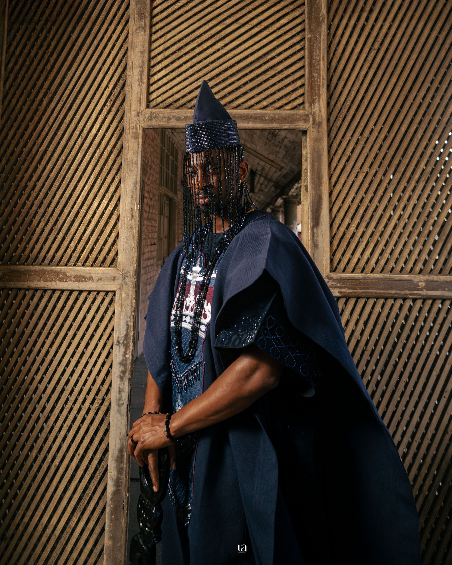 Artistic sequence of someone in dark clothing against a slatted wooden background.