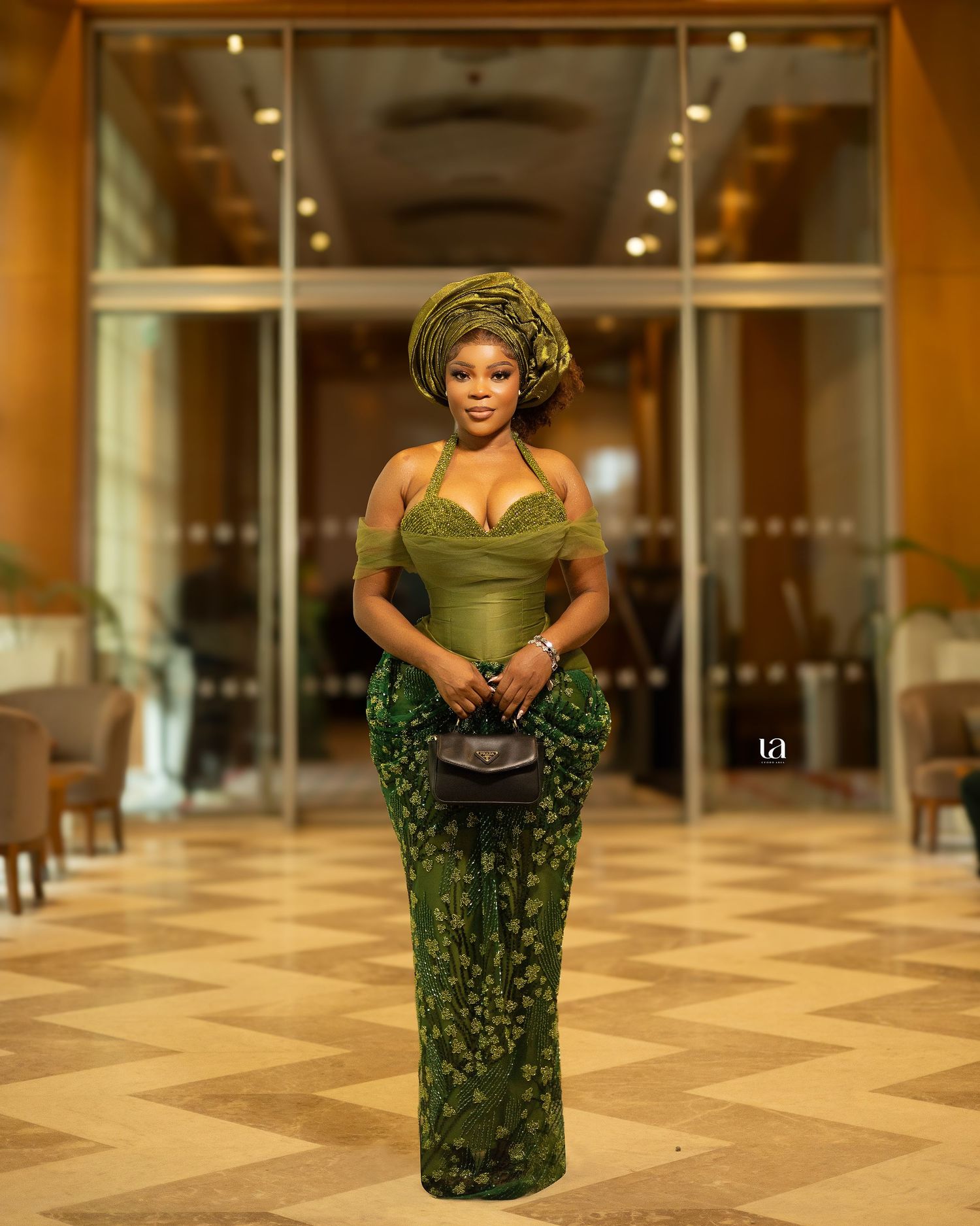 Fashion photo series in olive and green patterned dress against marble floor interior.