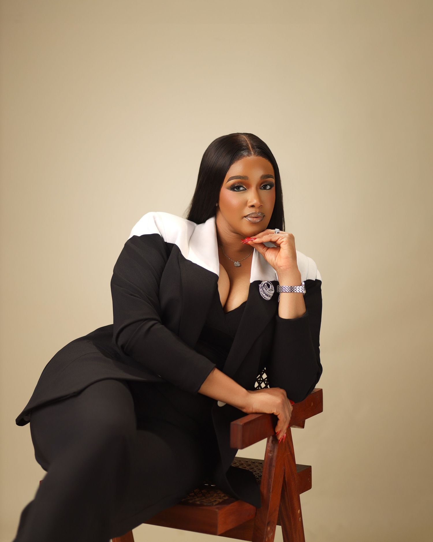 Artistic photo sequence showing dramatic poses in a black outfit against beige backdrop.