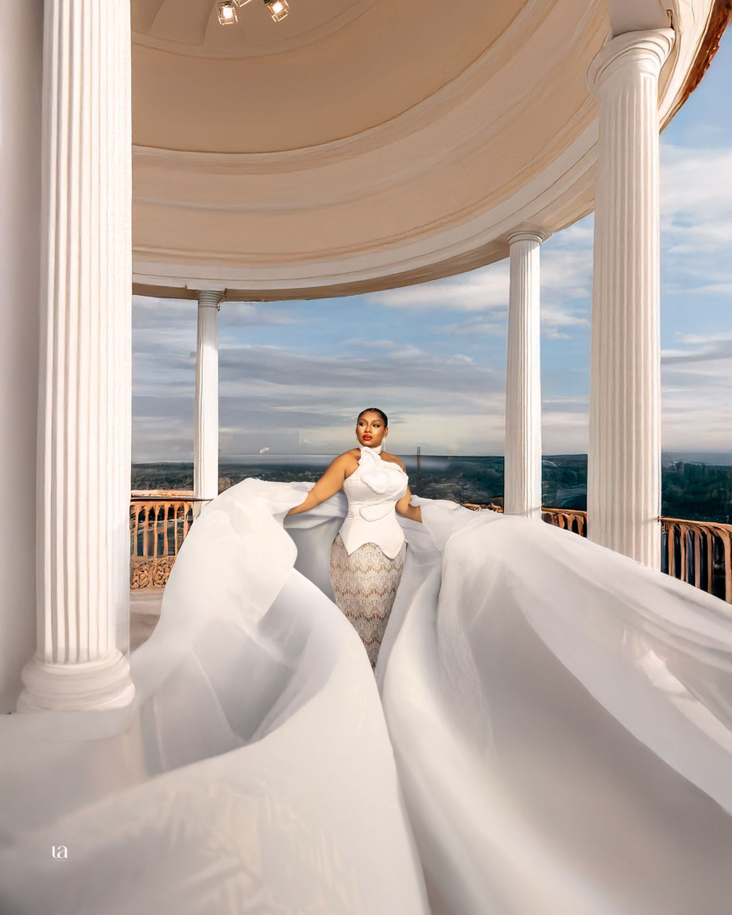 Stunning bridal portrait series with billowing dress at classical columned pavilion.