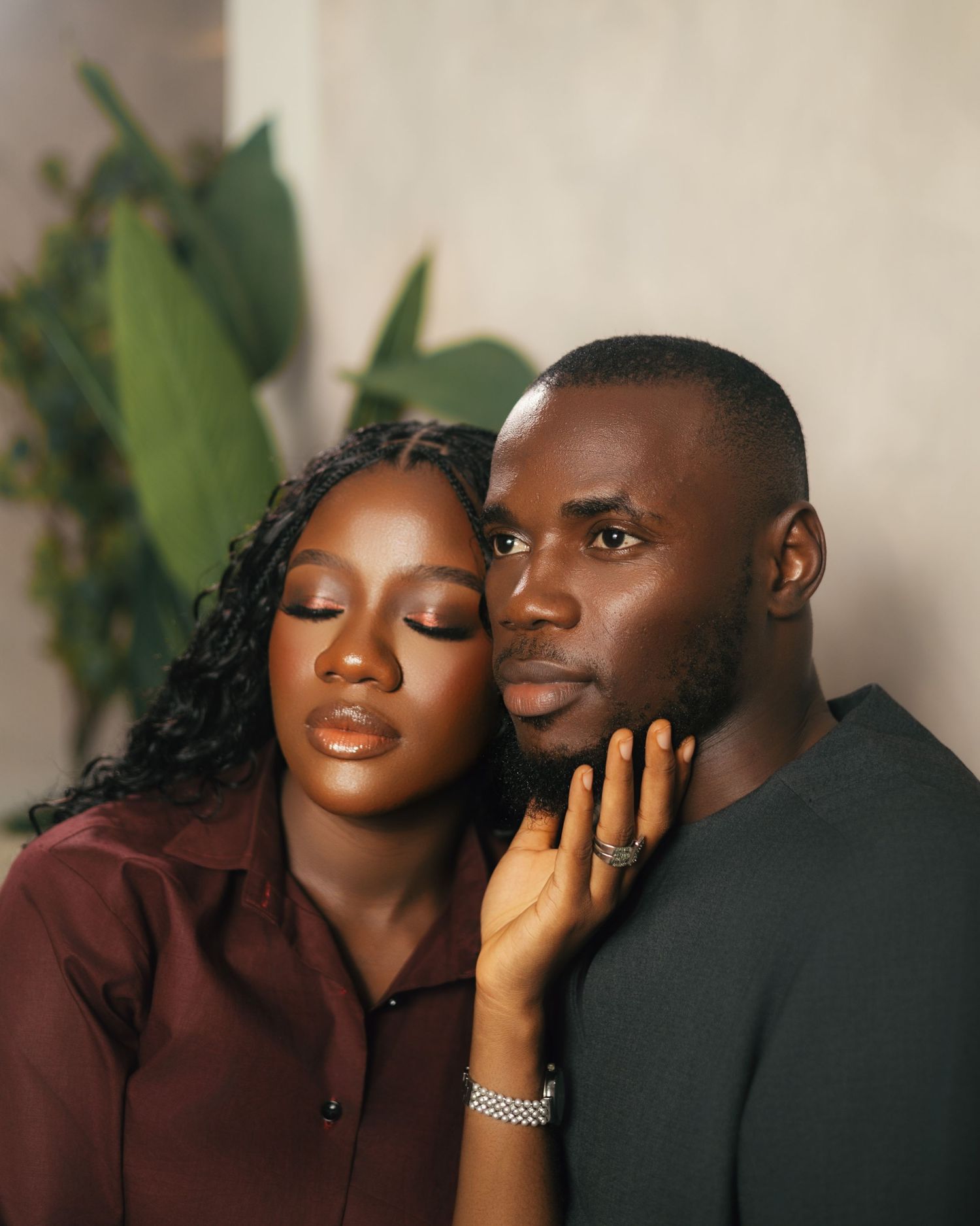 Romantic couple portrait series in burgundy attire showing tender affection.
