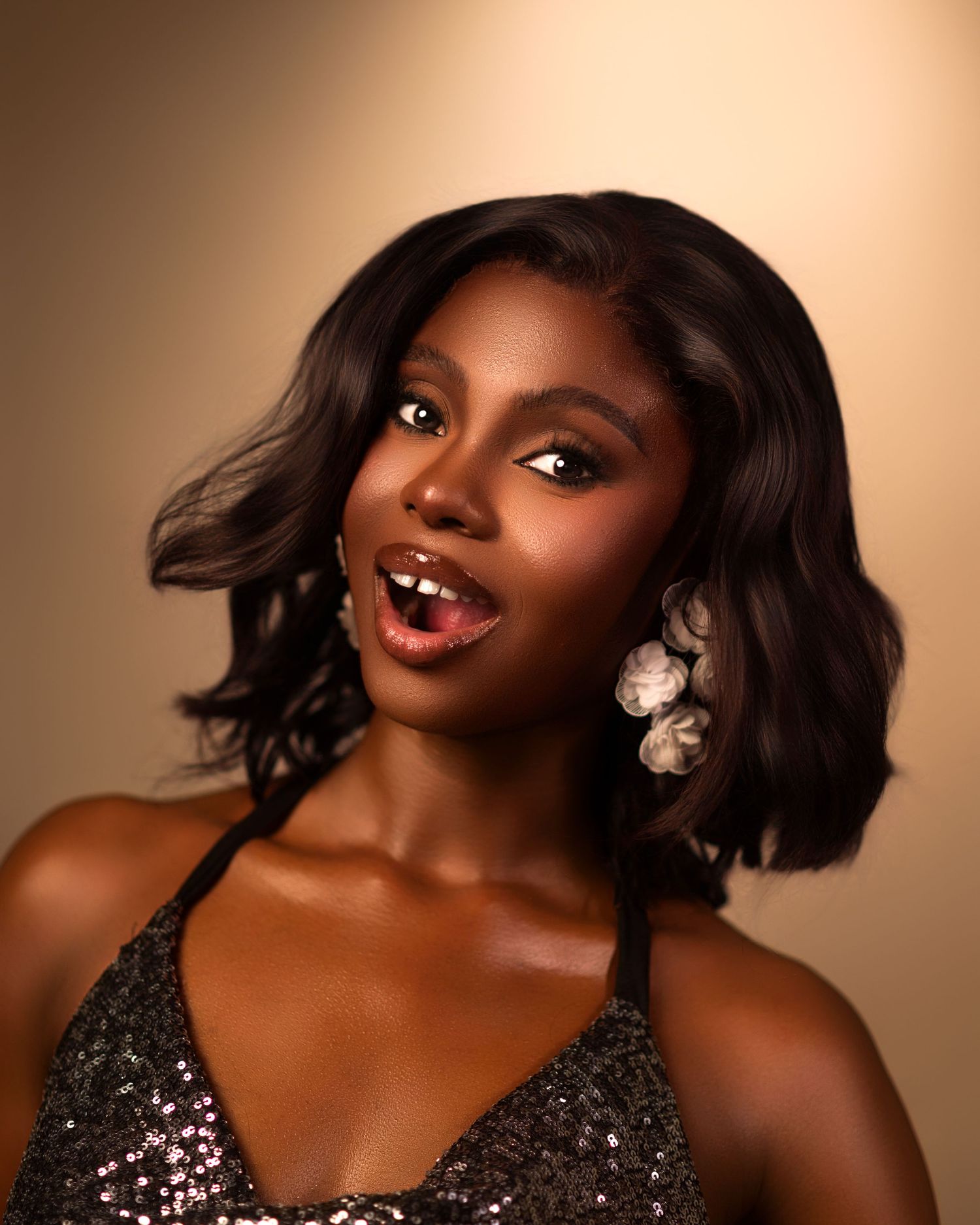 Elegant evening photoshoot featuring sparkly black gown and statement jewelry.