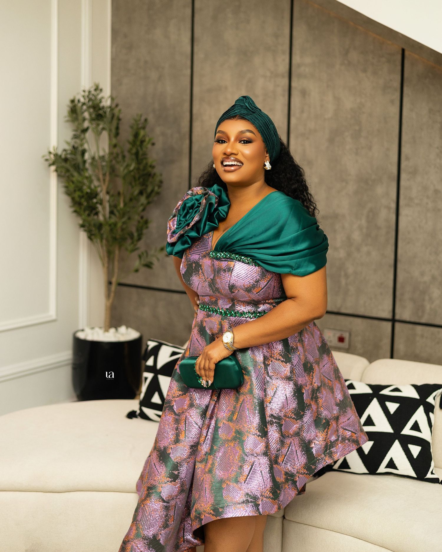 Lifestyle photo session on white couch featuring floral print dress and teal wrap.