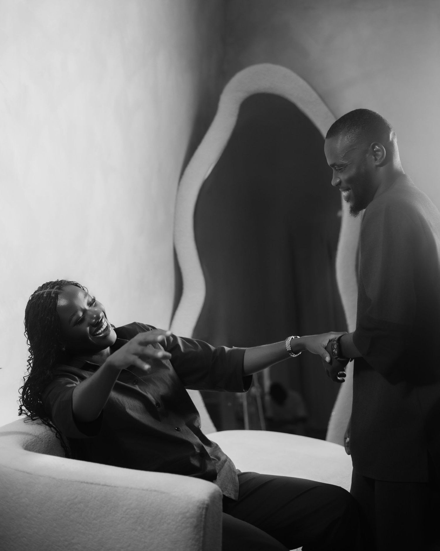 Artistic black and white photo series showing intimate couple moments in dramatic lighting.