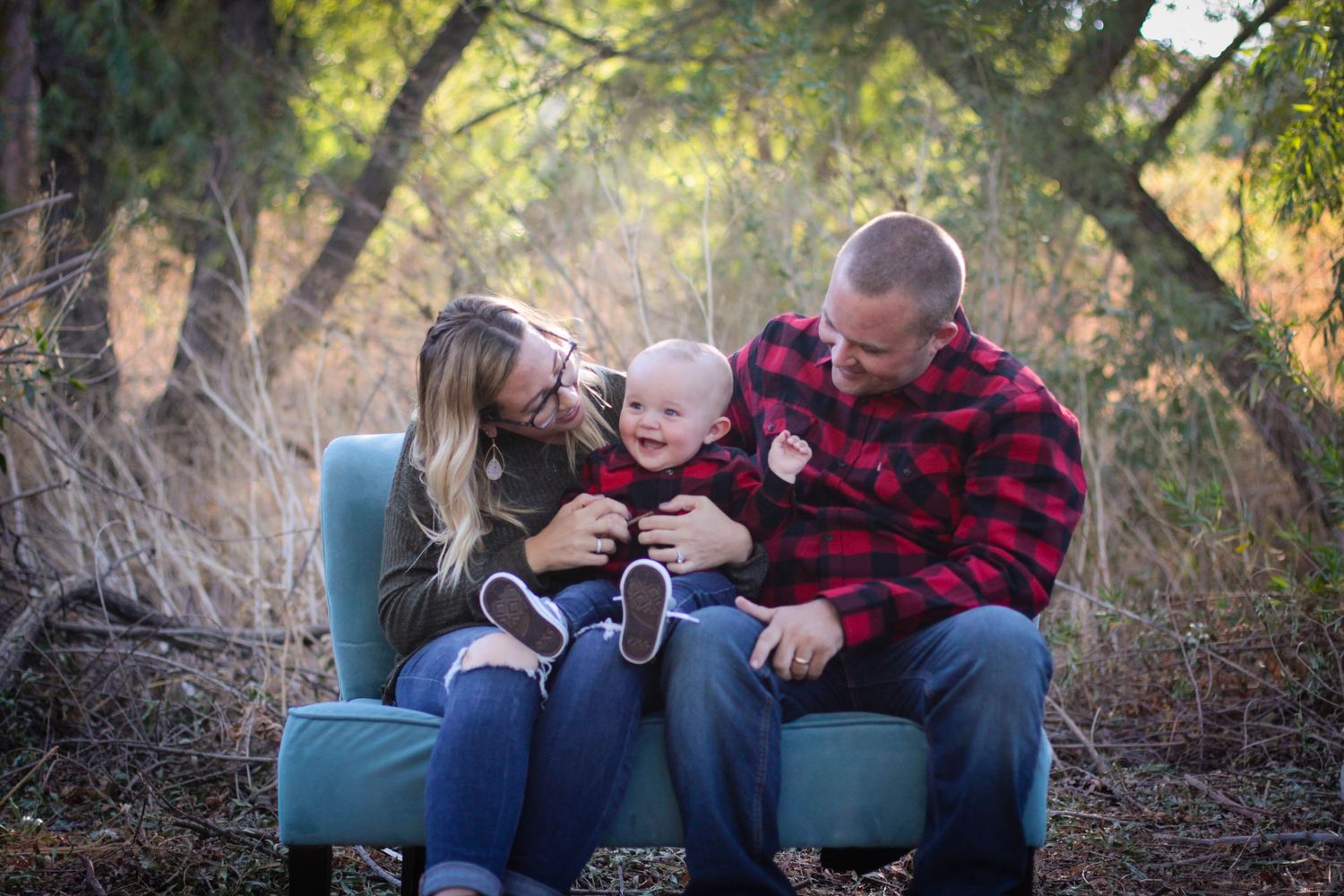 Family members share tender moments while sitting on outdoor furniture.