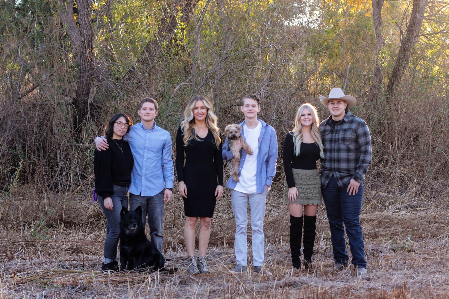 Extended family gathering outdoors for group photos in casual attire.