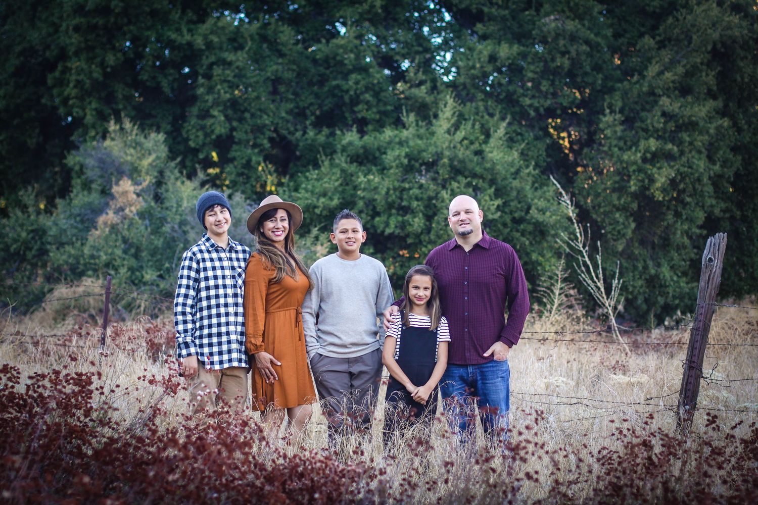 Group portrait of family members arranged in casual poses outdoors.