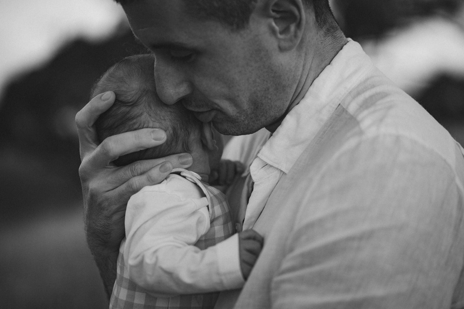 A black and white photo shows someone holding their hand over their face in a gesture of distress or frustration.