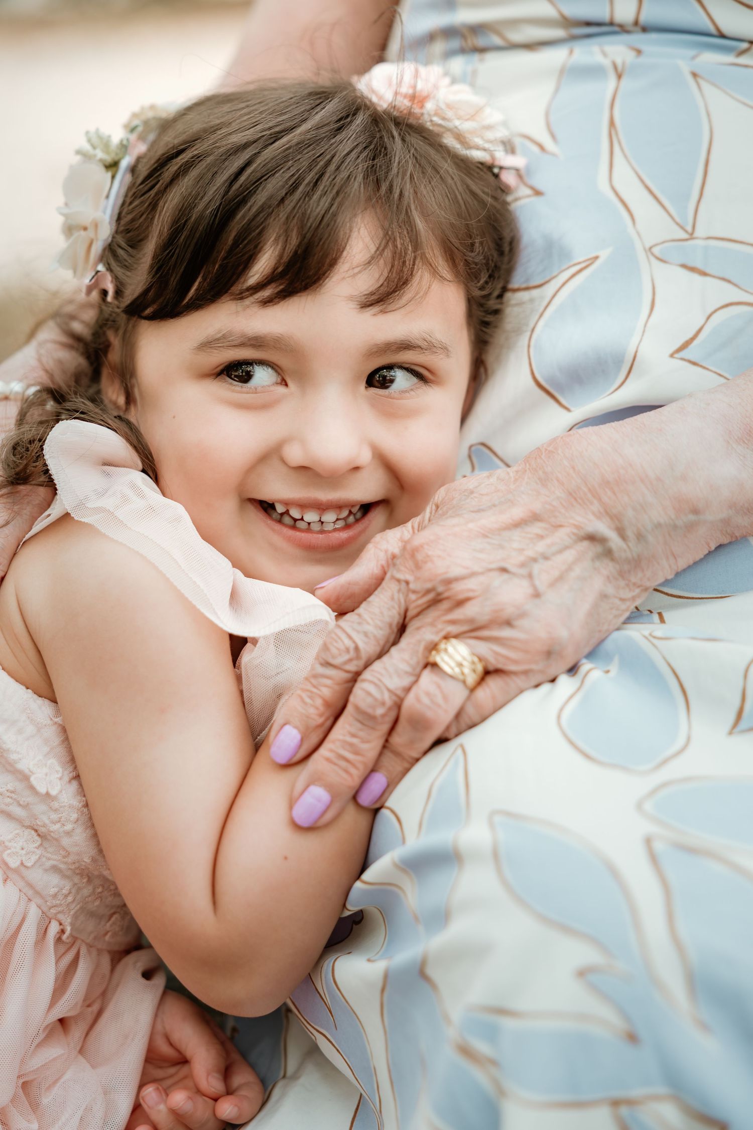 Close-up candid shots showing playful expressions and gentle touches against blue background.