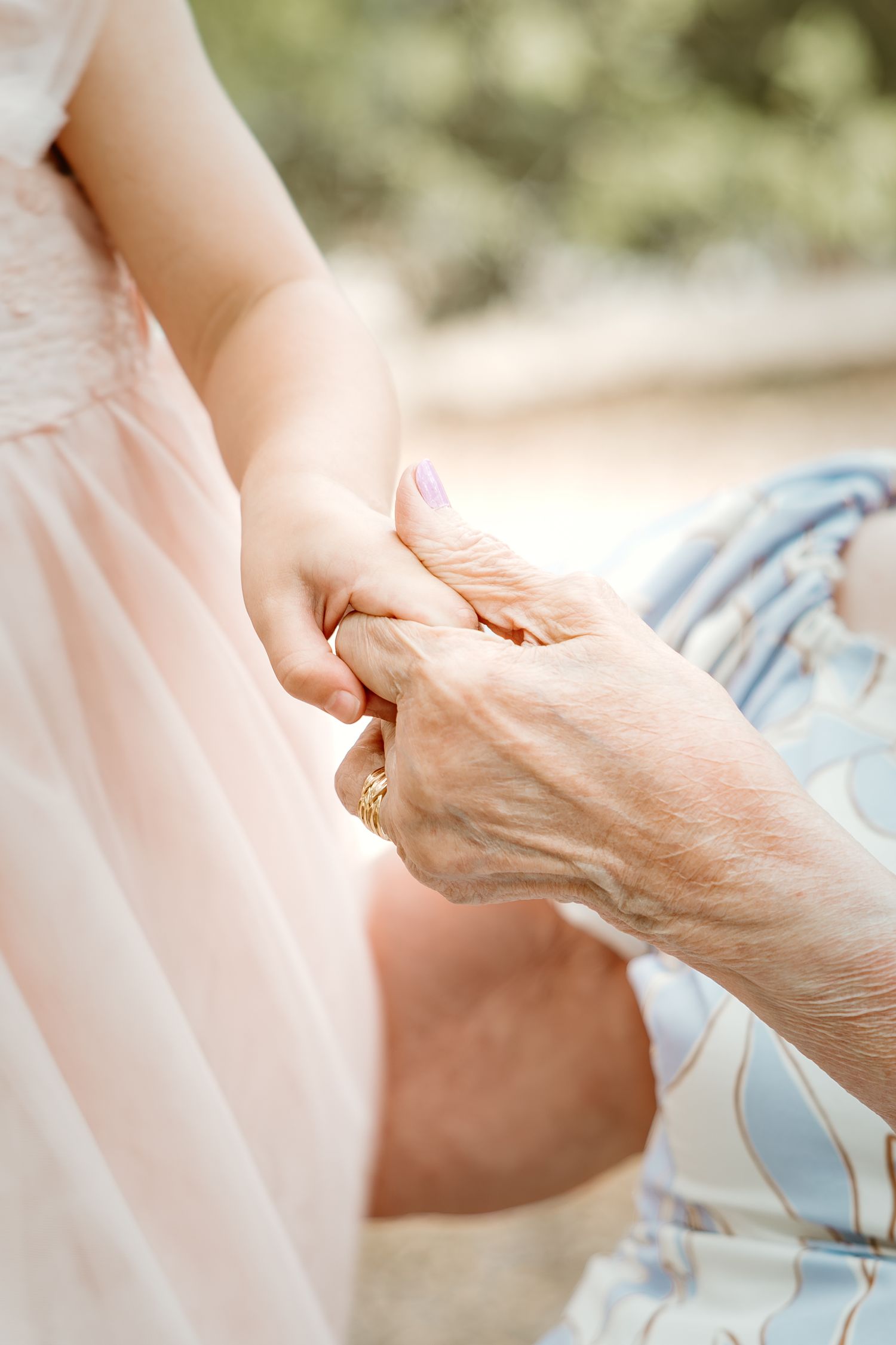 Close-up series of hands gently touching, showing tender connection between generations.