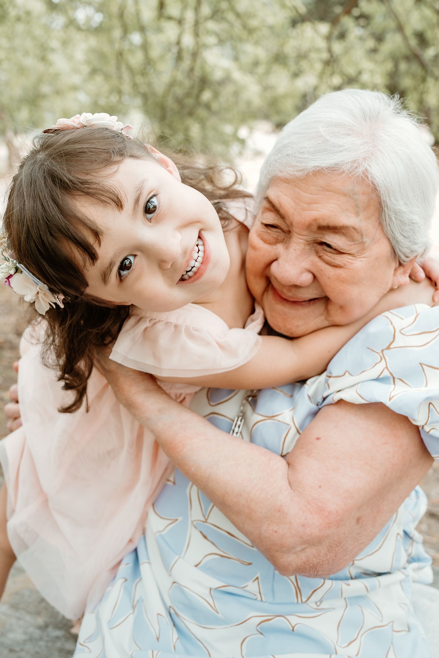 A tender moment captured showing affectionate embraces and joyful expressions in an outdoor setting.