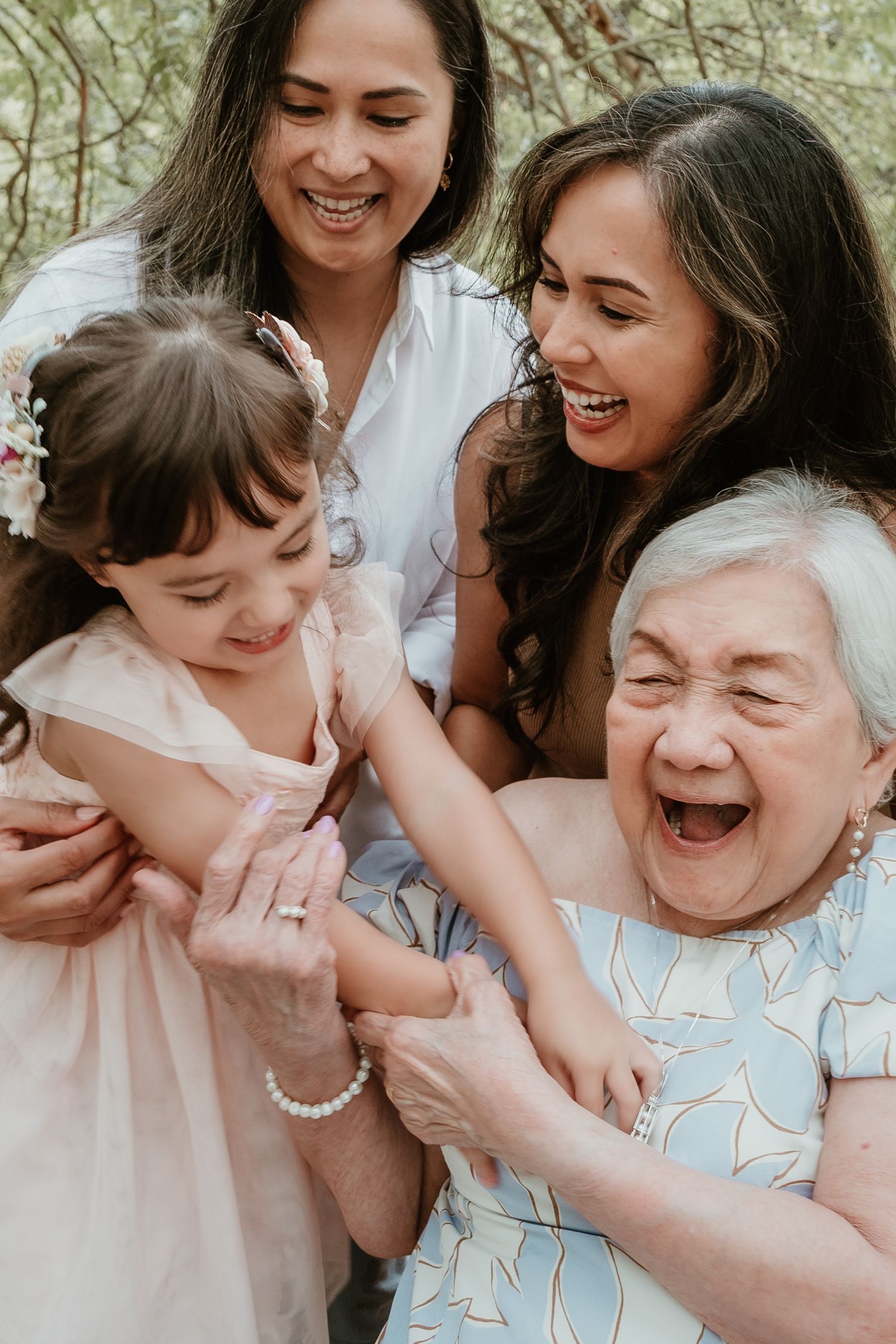 Candid moments of laughter and joy shared between family members in a natural outdoor setting.