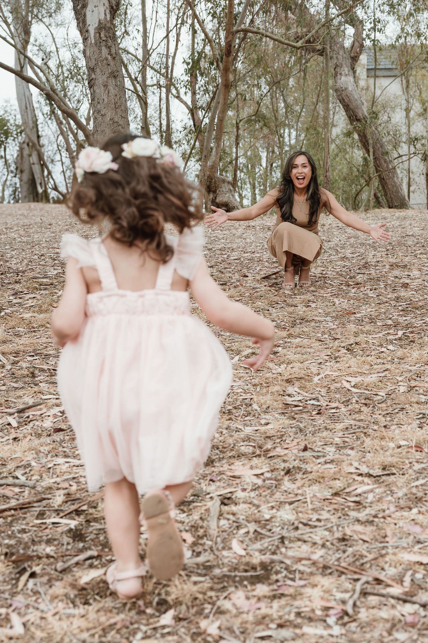 A series of photos showing someone in a flowing pink dress twirling and dancing through a wooded forest area.