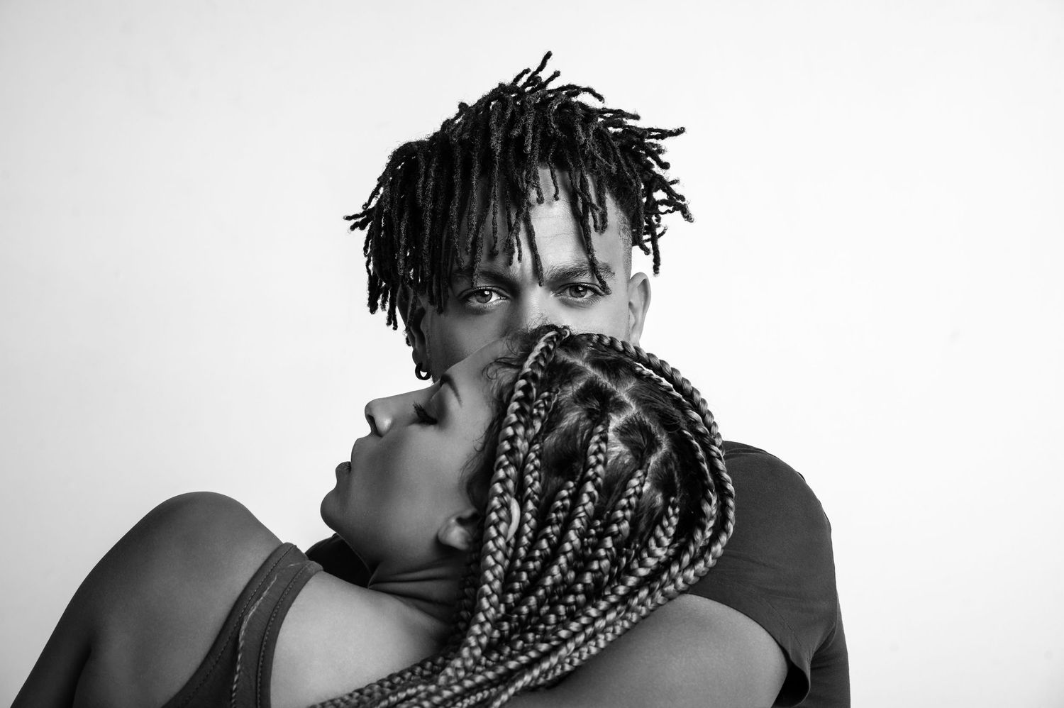 Black and white artistic portrait series showing close-up profile views of a person with braided hair against white backdrop.