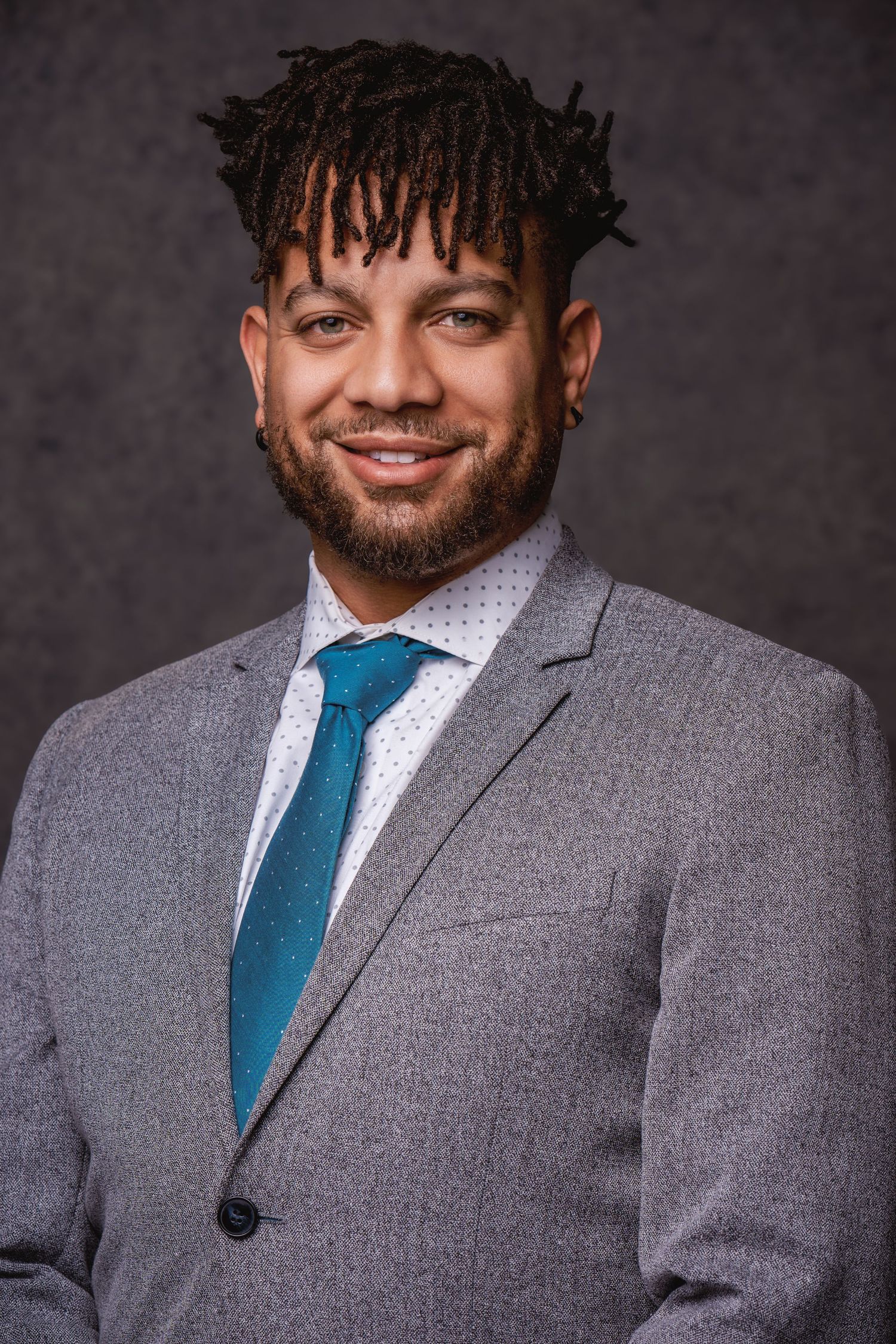 Professional headshot series showing a person in a gray suit and blue tie against a dark background.