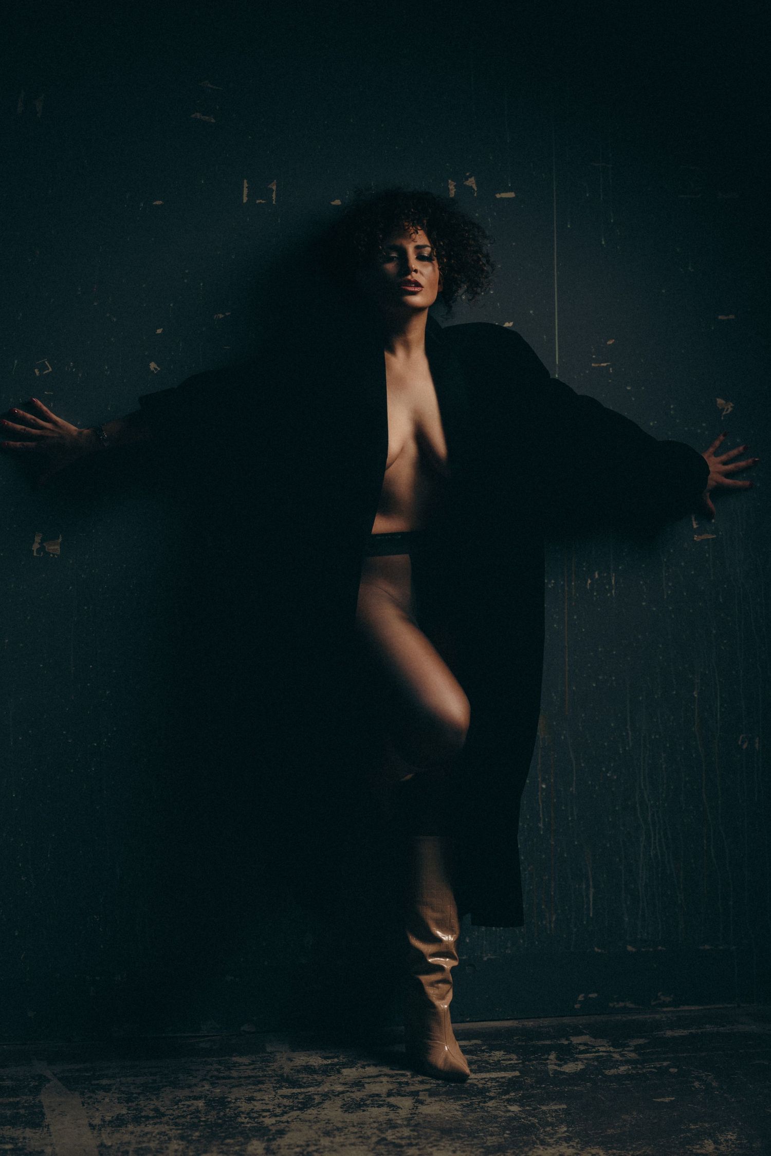 Dramatic silhouette dance poses captured in dark moody lighting against black background.