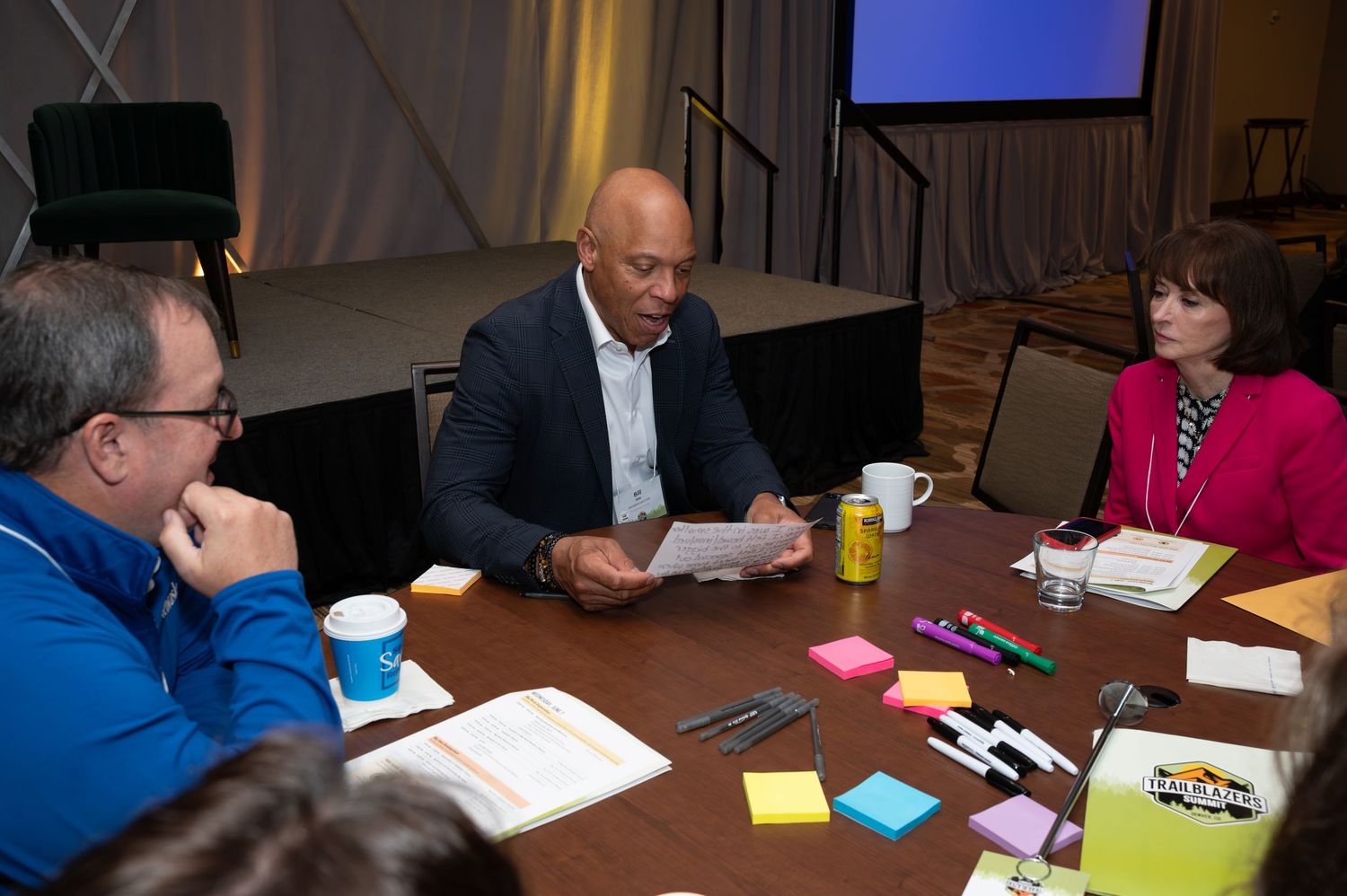 Professional team collaborating at a conference table with office supplies.