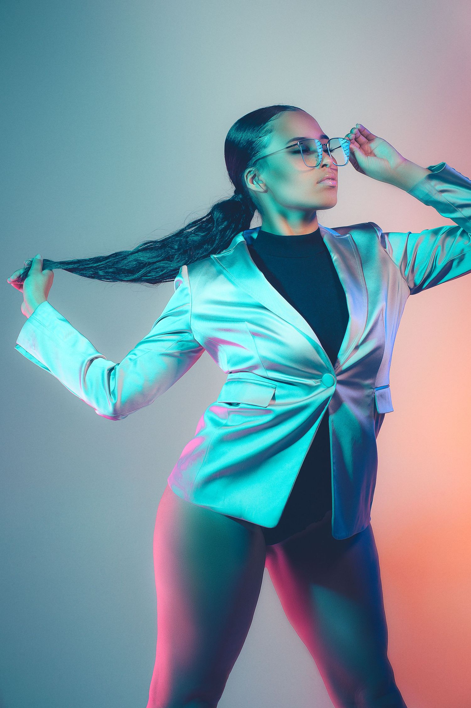 Artistic fashion photo sequence showing dancer in black and turquoise lighting performing dynamic movement poses.