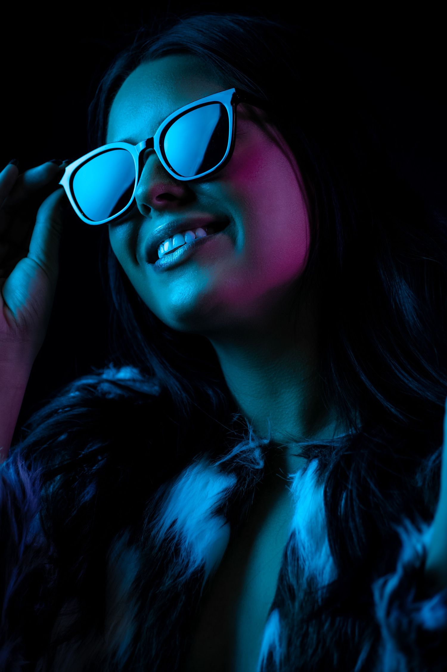 Artistic portrait series with neon blue lighting showing person in glasses against dark background with dramatic shadows.