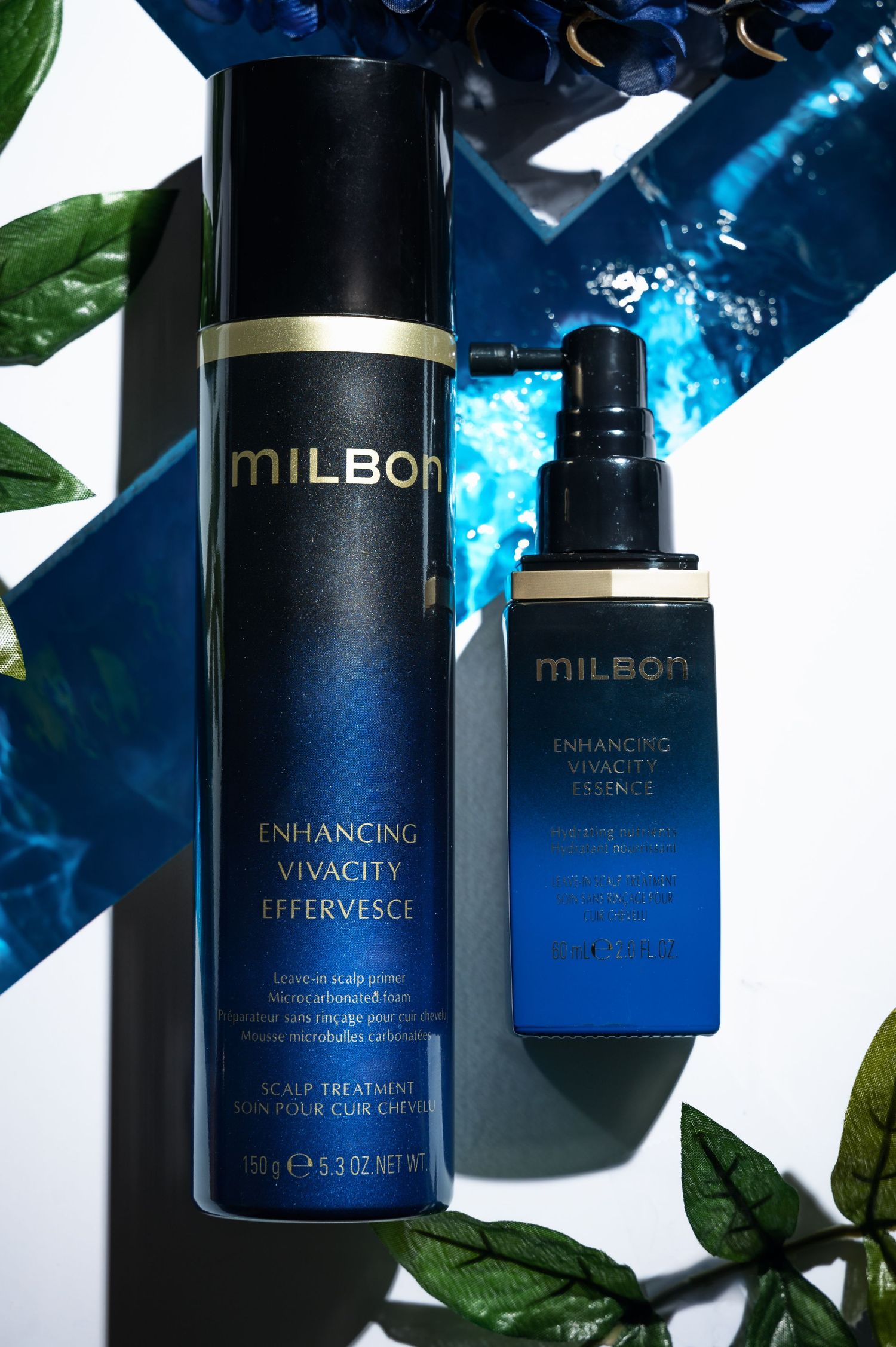 Two black Milbon hair care product bottles with blue reflections against a dark background with green leaves.