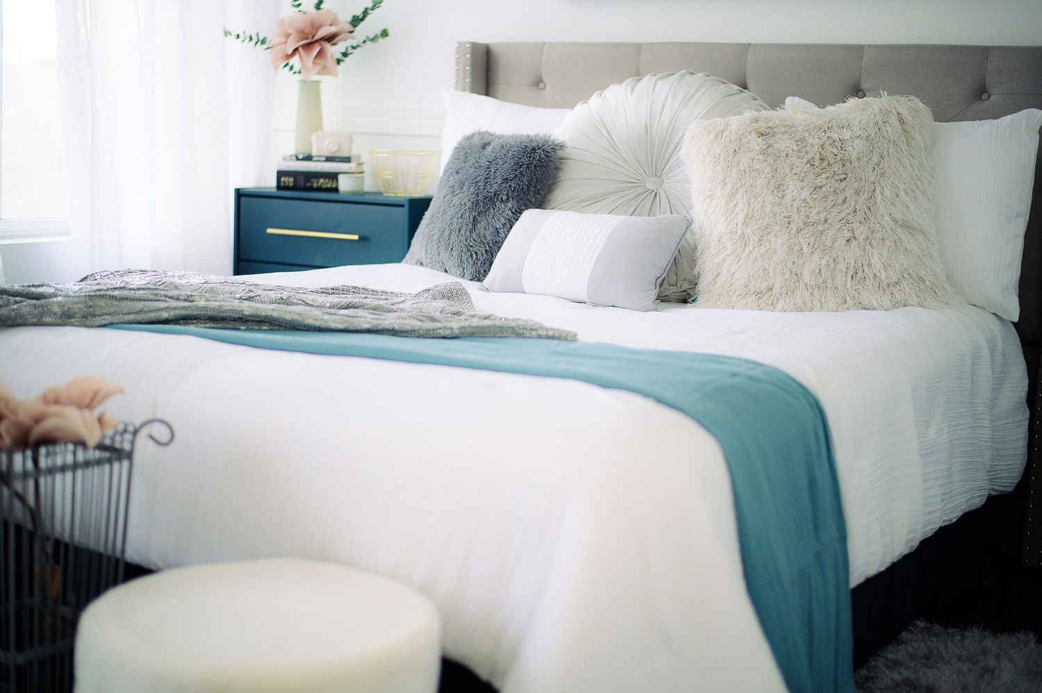A series of cozy bedroom scenes showing white bedding and teal accents with plush pillows and textured throws.