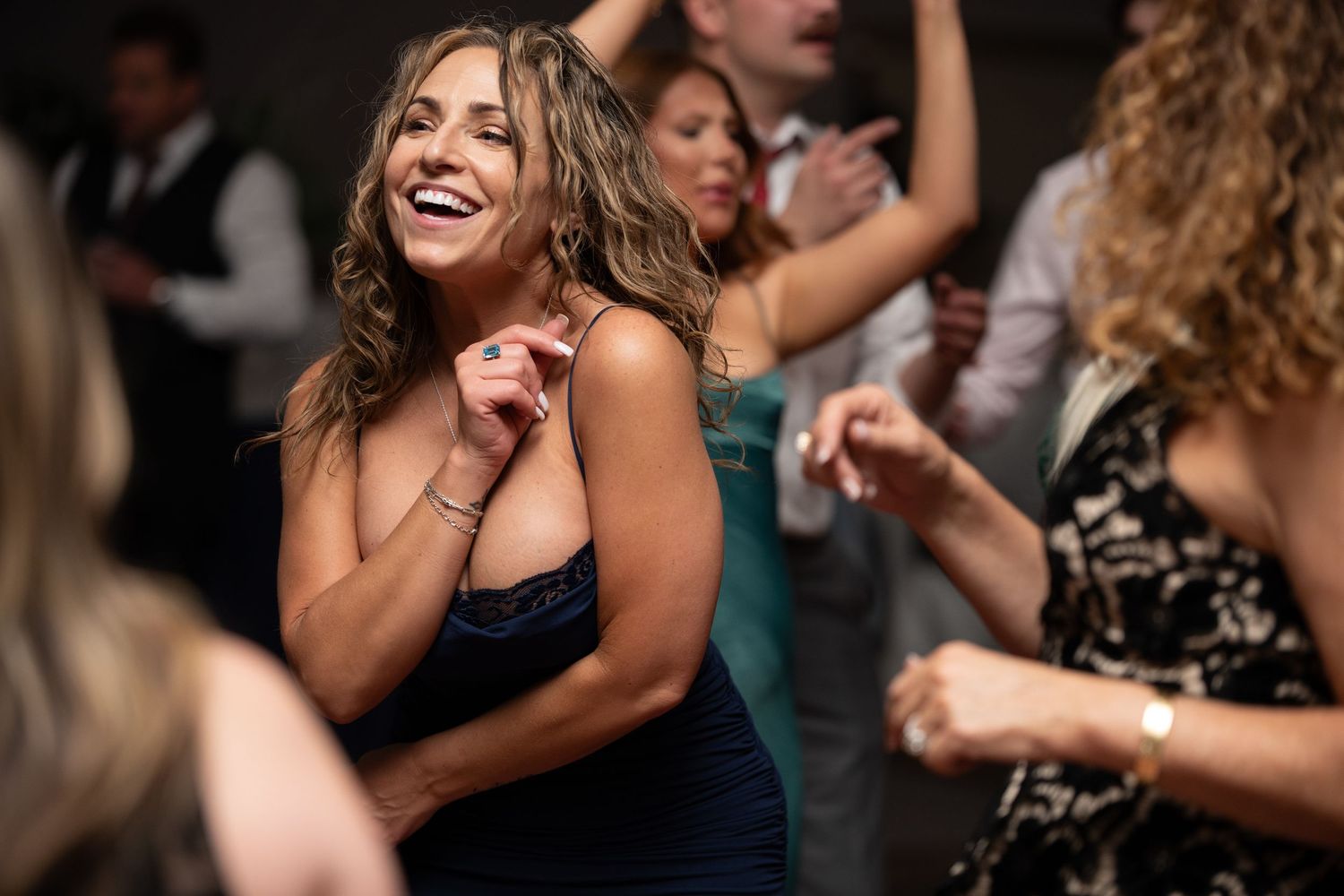 A group of joyful people dancing and celebrating at a lively party or event.