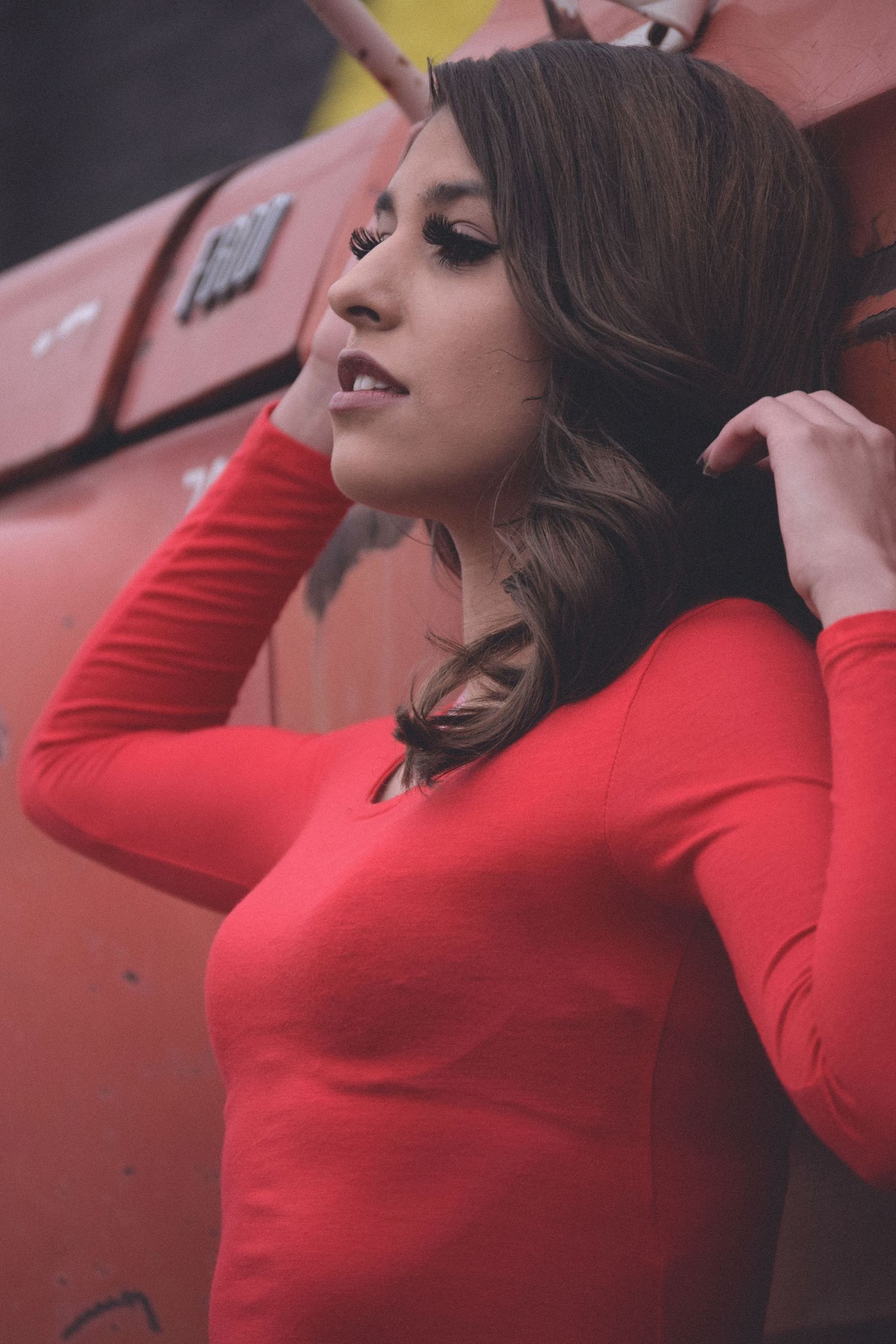 Fashion portrait series in red sweater against pink background showing dynamic poses and movement.