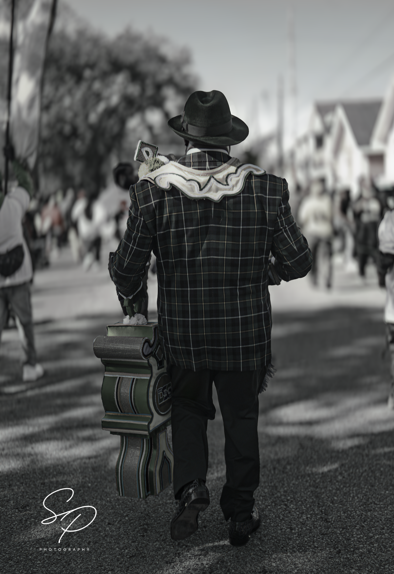 A black and white photo sequence shows a person in a plaid jacket and hat walking with a small child down a street.