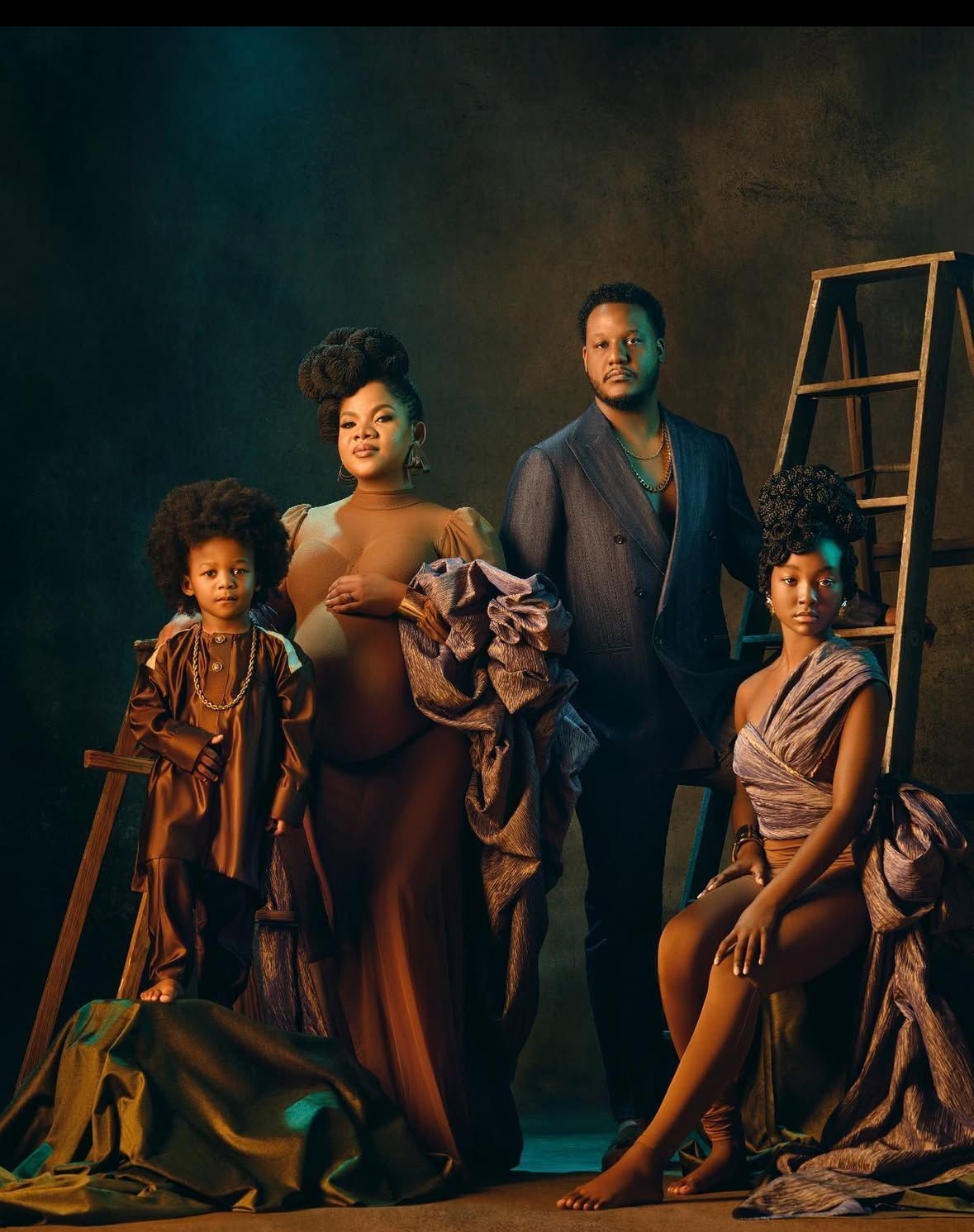 Dramatic artistic photo series showing figures in moody lighting and flowing fabrics.