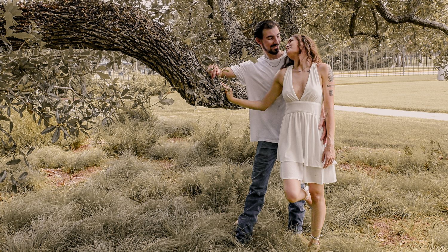Romantic engagement photo shoot in rustic outdoor setting with natural lighting.