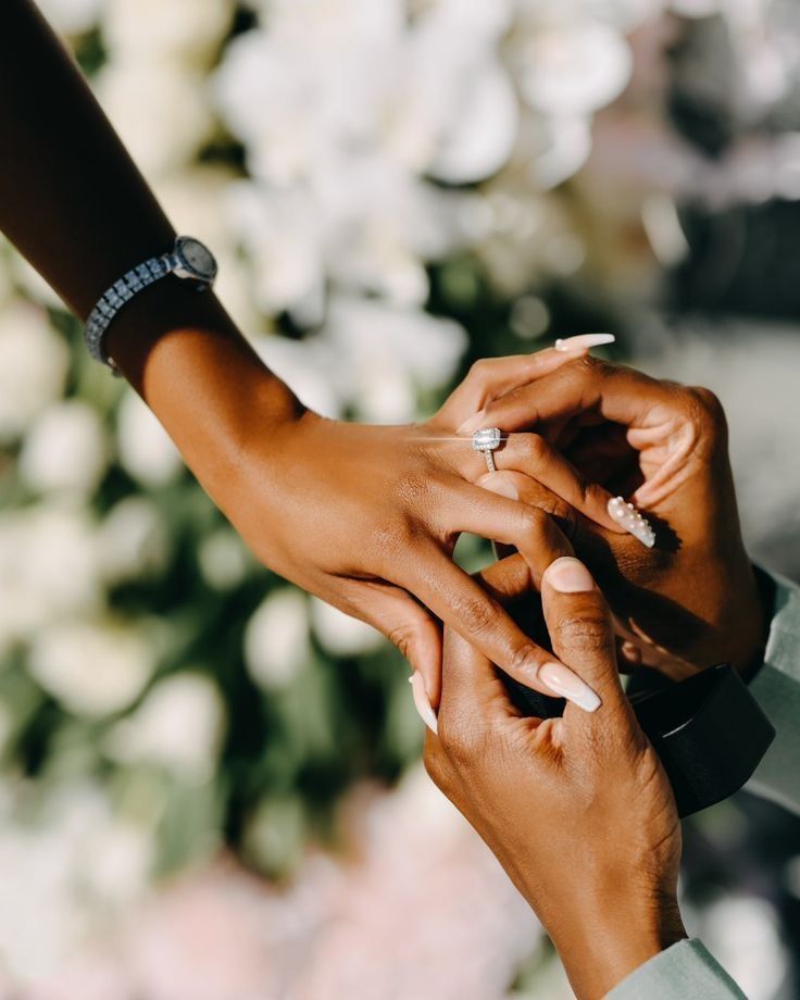 Close-up of hands exchanging rings during a special moment.