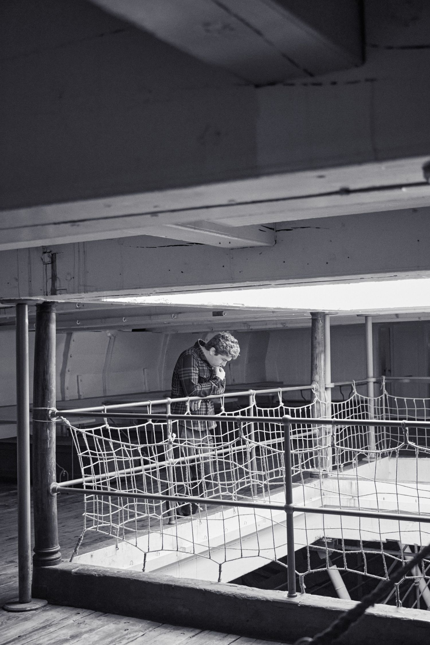 Abandoned ship interior with empty metal shopping carts and fluorescent lighting.
