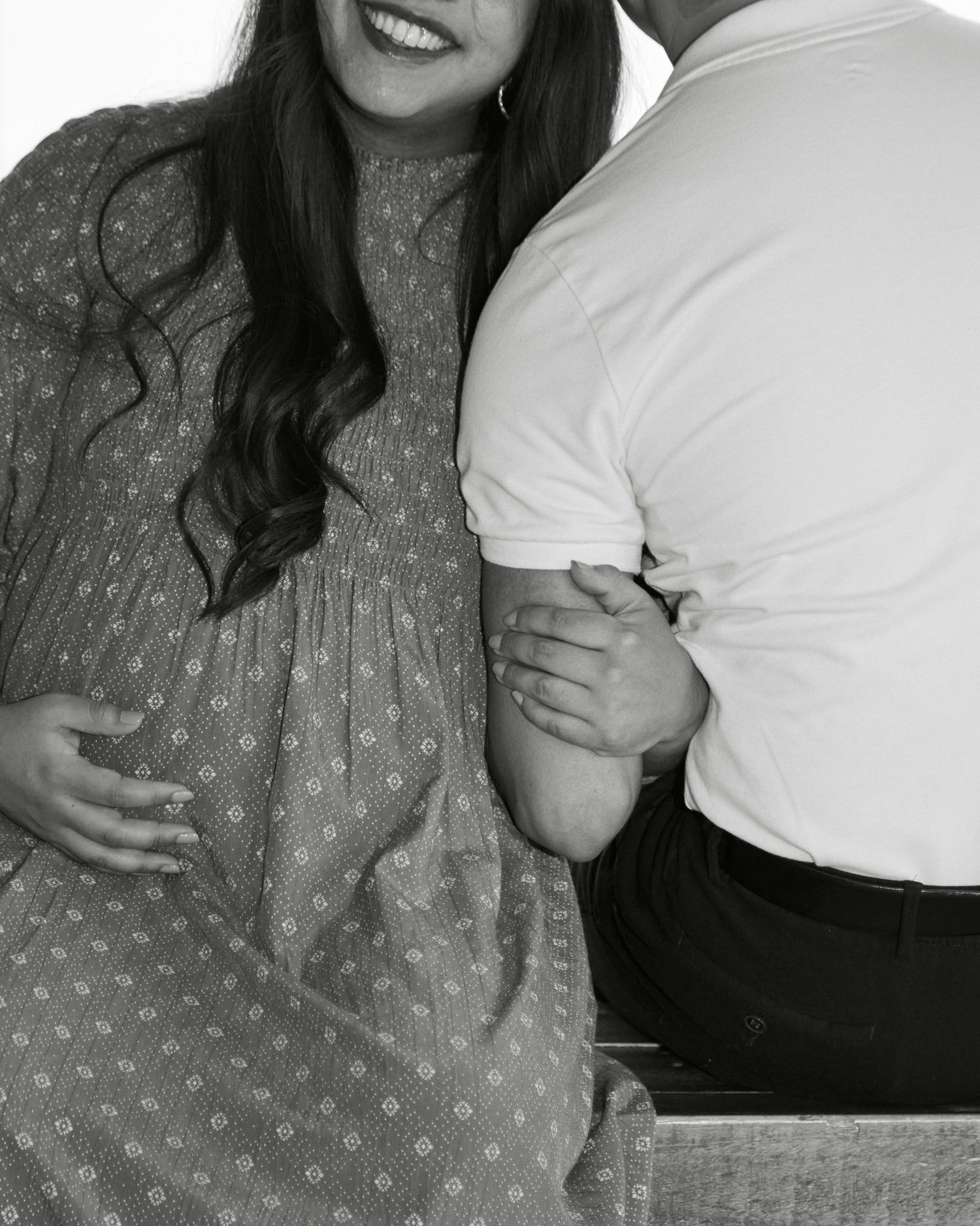 Black and white intimate moment captured showing green polka dot dress.