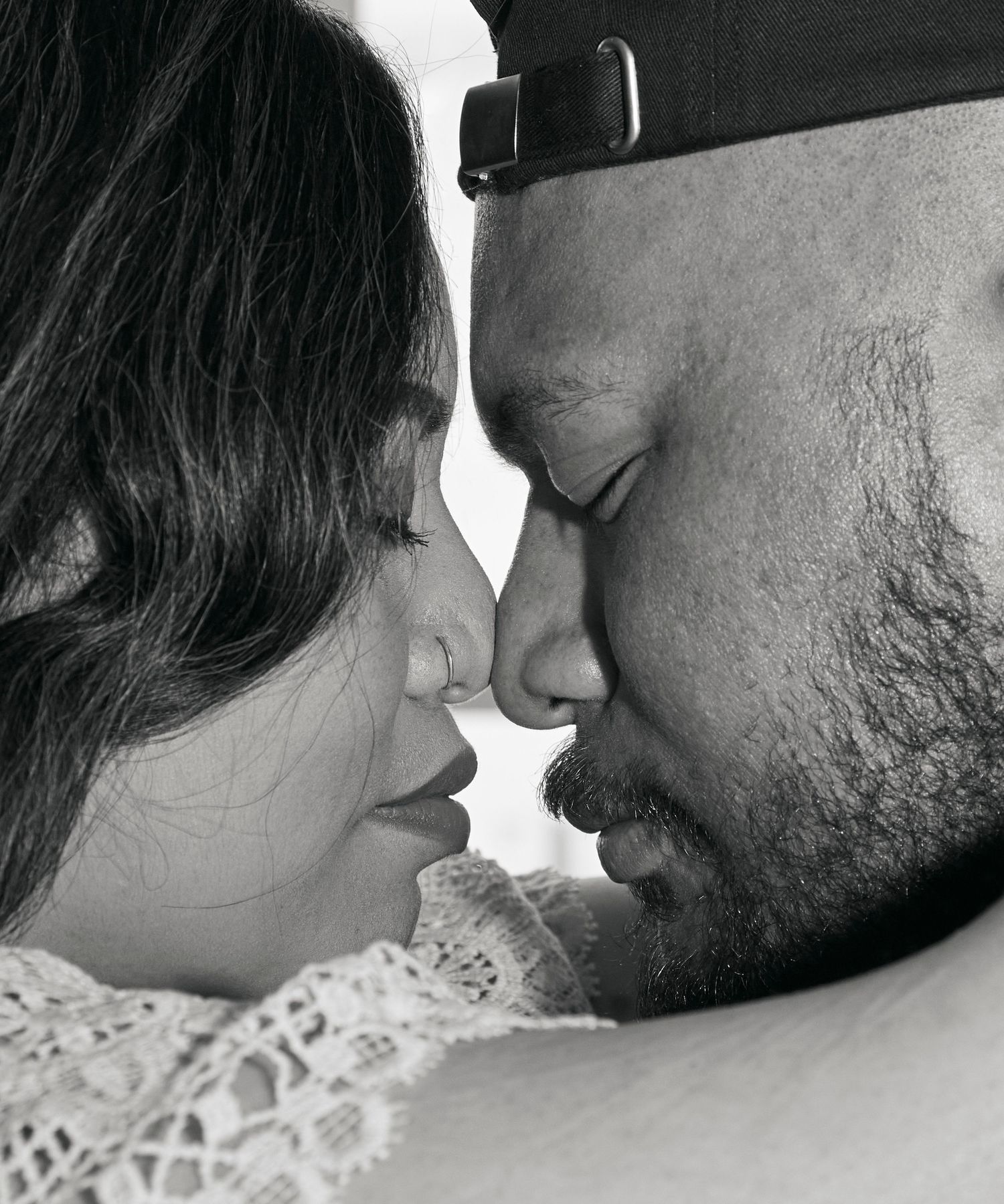 An intimate black and white close-up portrait of a couple.