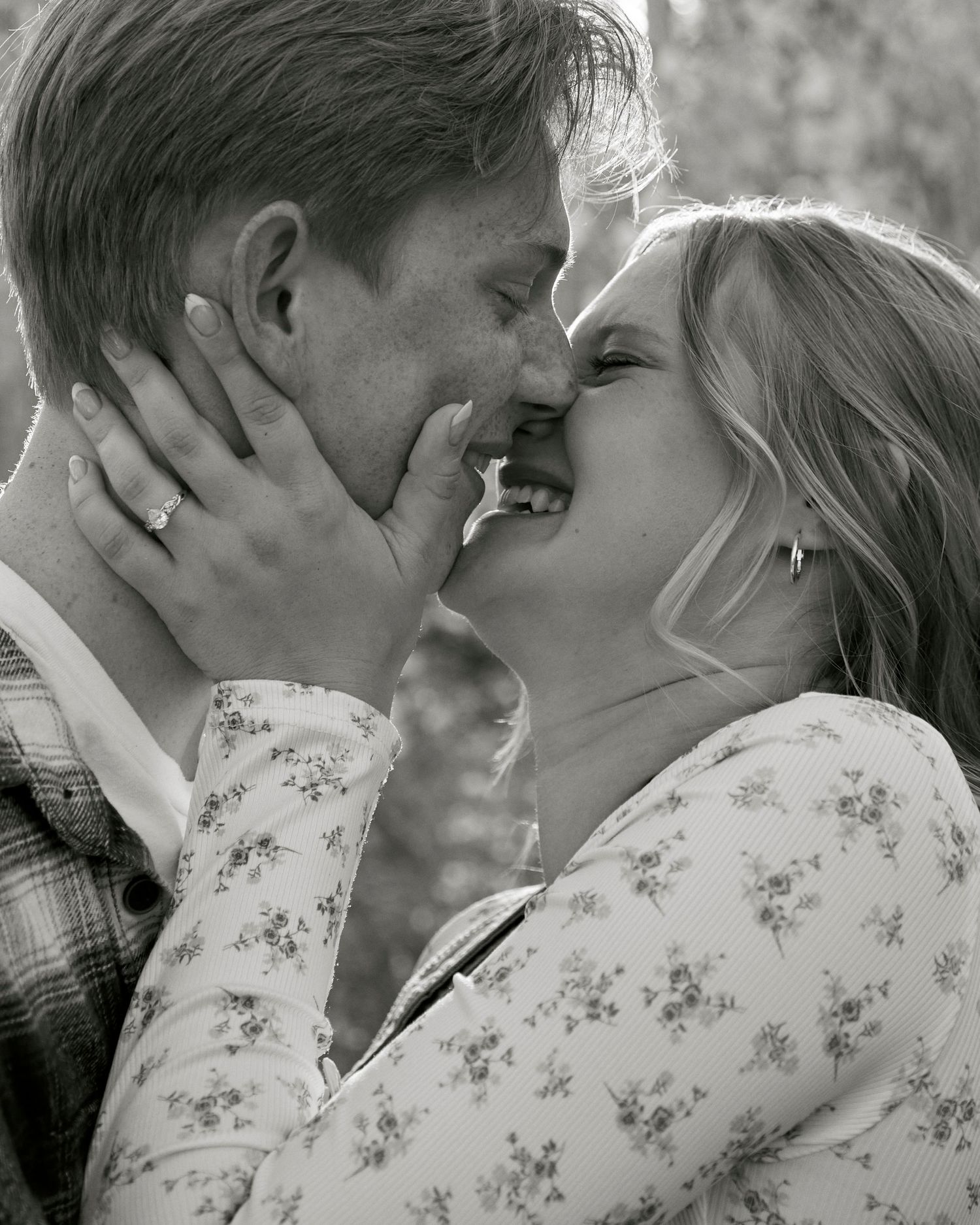Intimate black and white close-up of couple sharing a romantic moment.