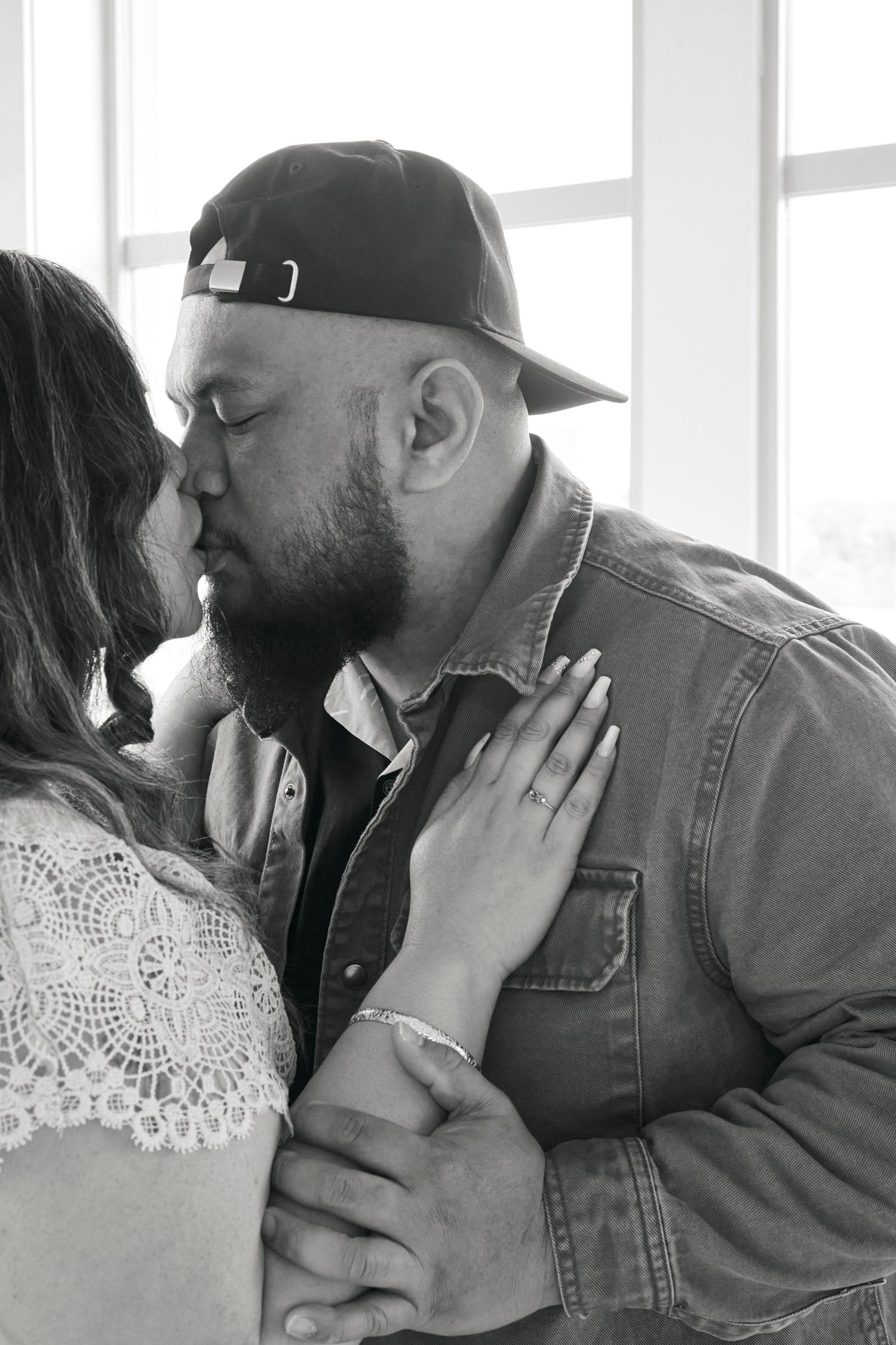 A close-up intimate moment captured in black and white.