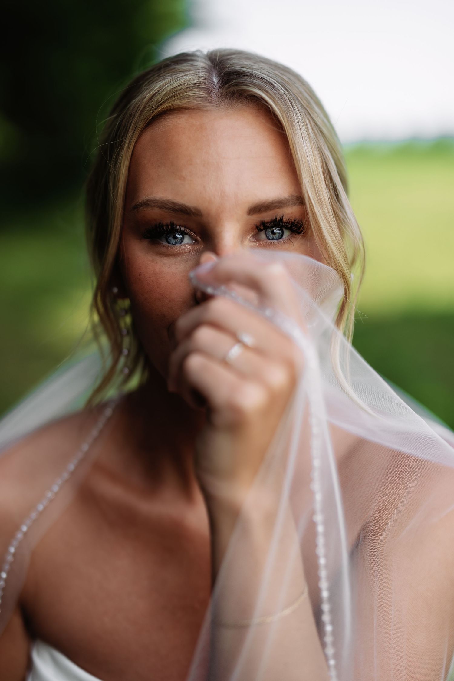 A bride wearing a delicate veil poses for a creative portrait series with varying focus and framing effects.
