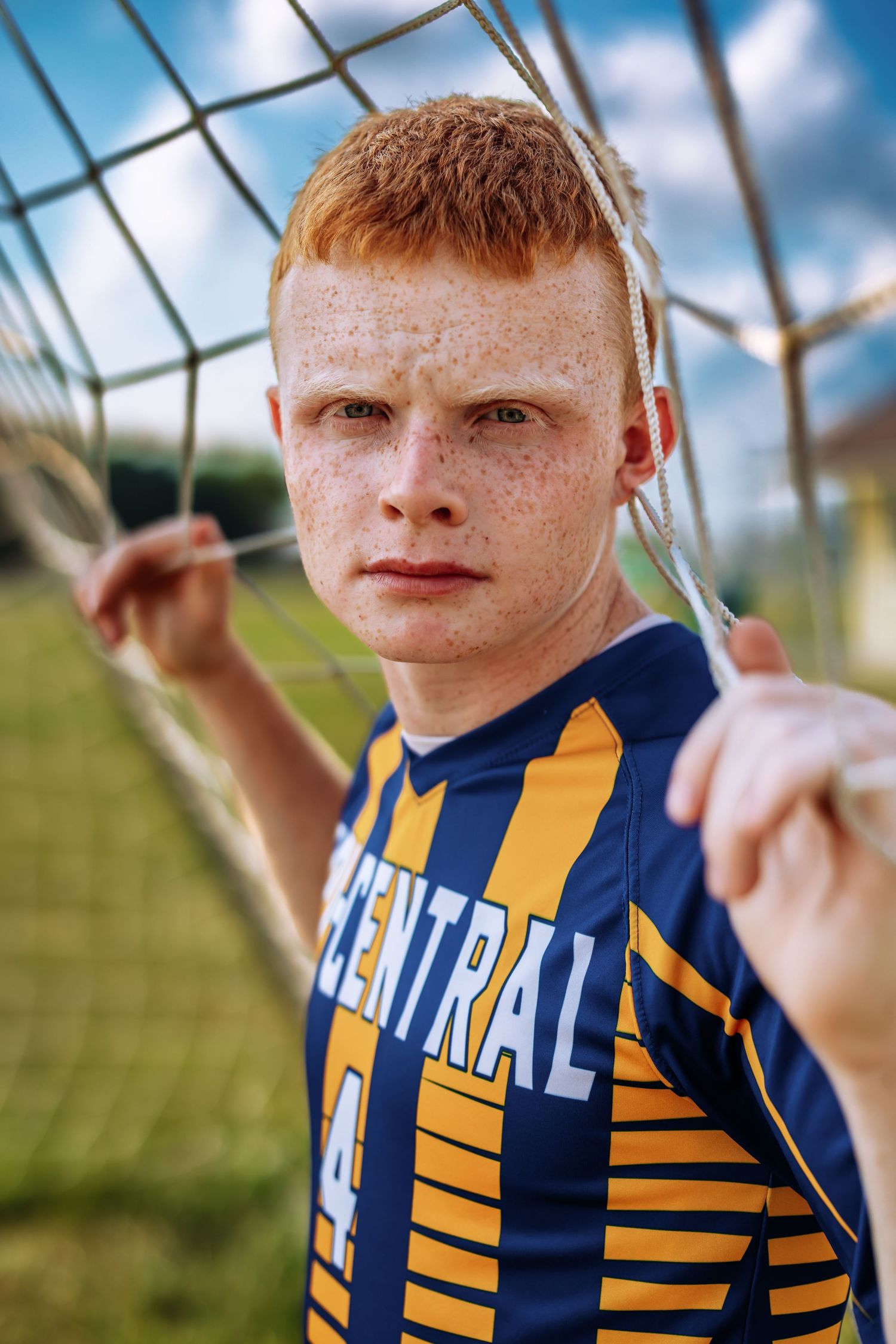 A sequence of close-up shots showing a soccer player in a navy and yellow striped jersey against a blurred background.
