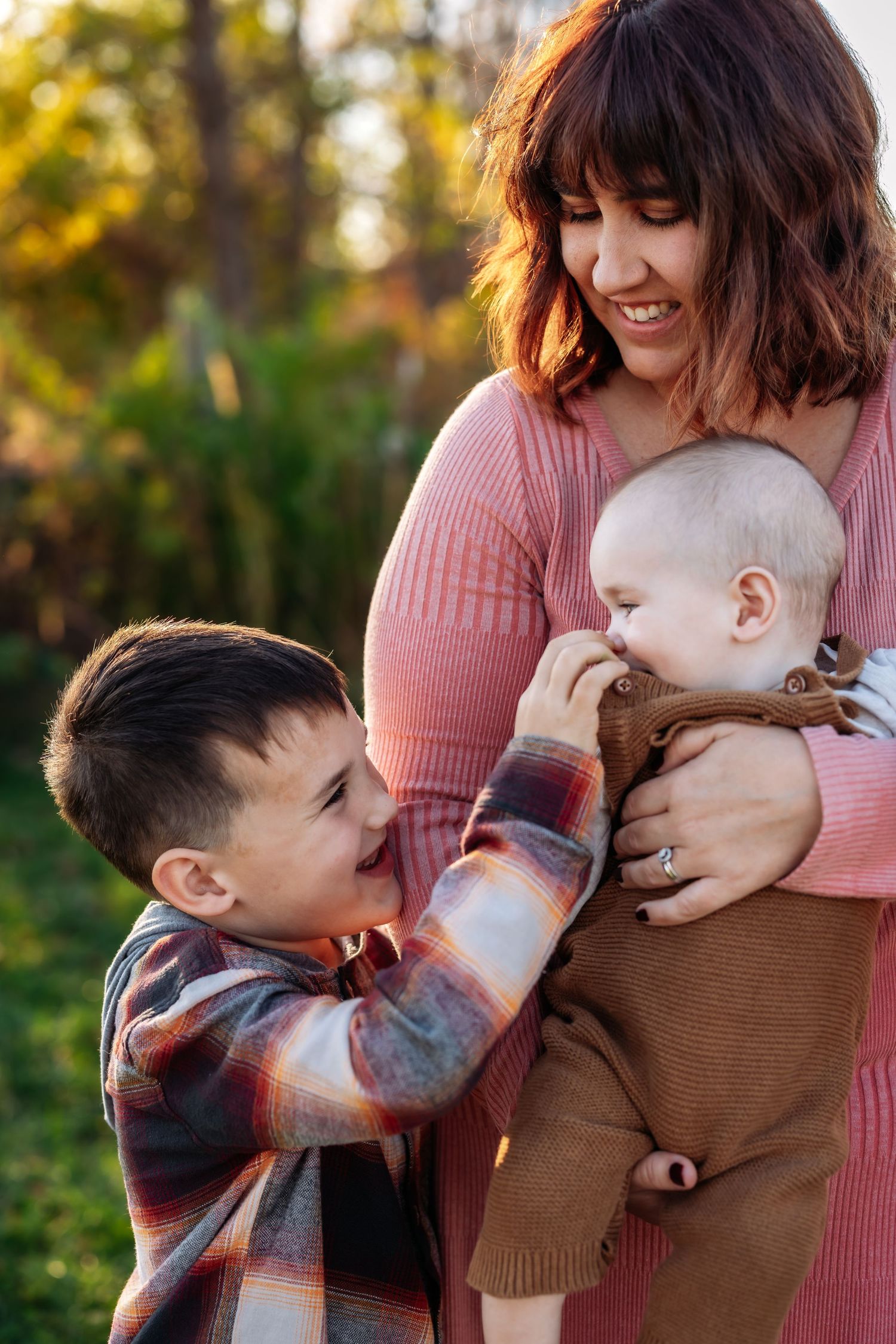 Heartwarming family moment captured outdoors in autumn lighting.
