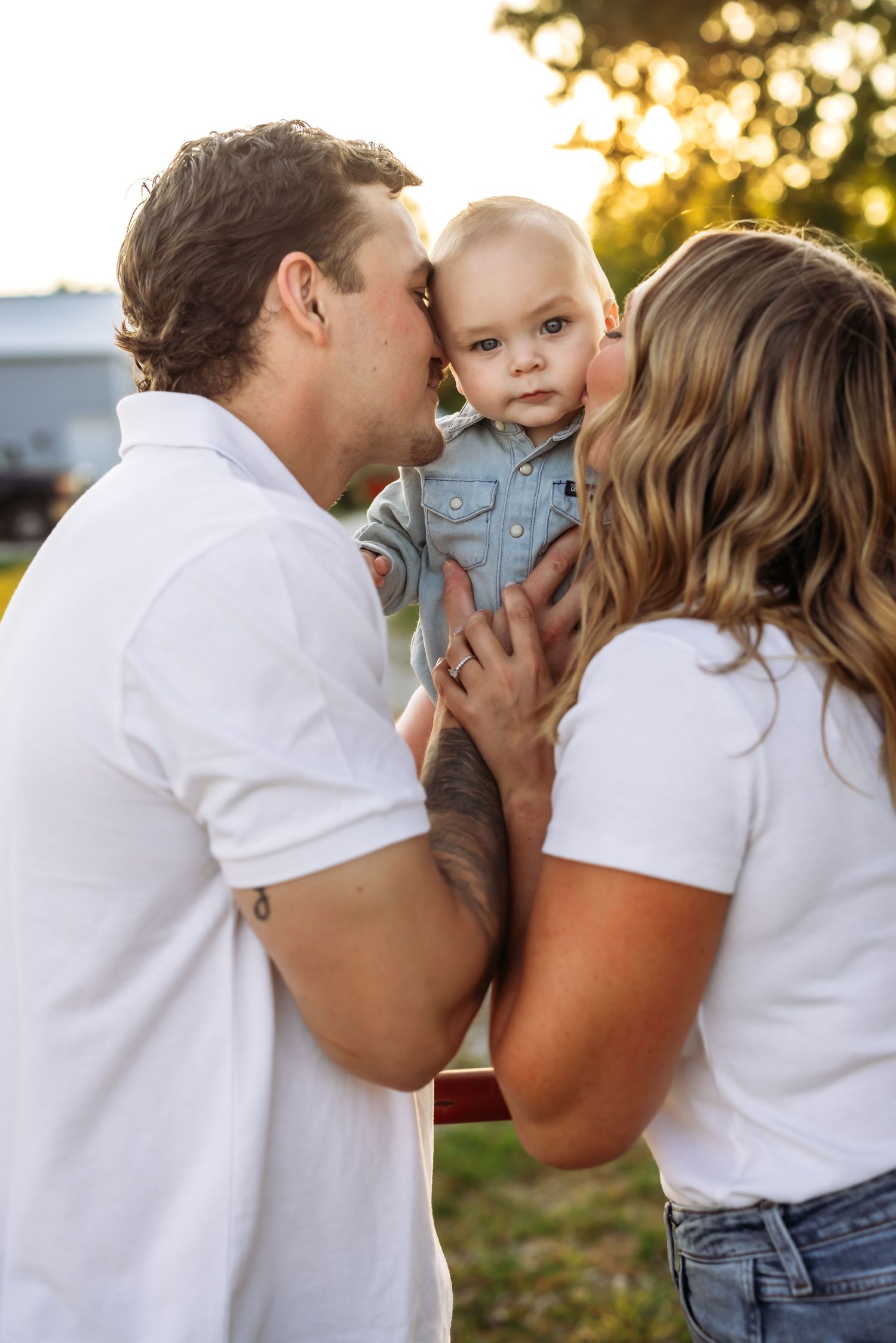 An intimate family moment captured during golden hour outdoors.