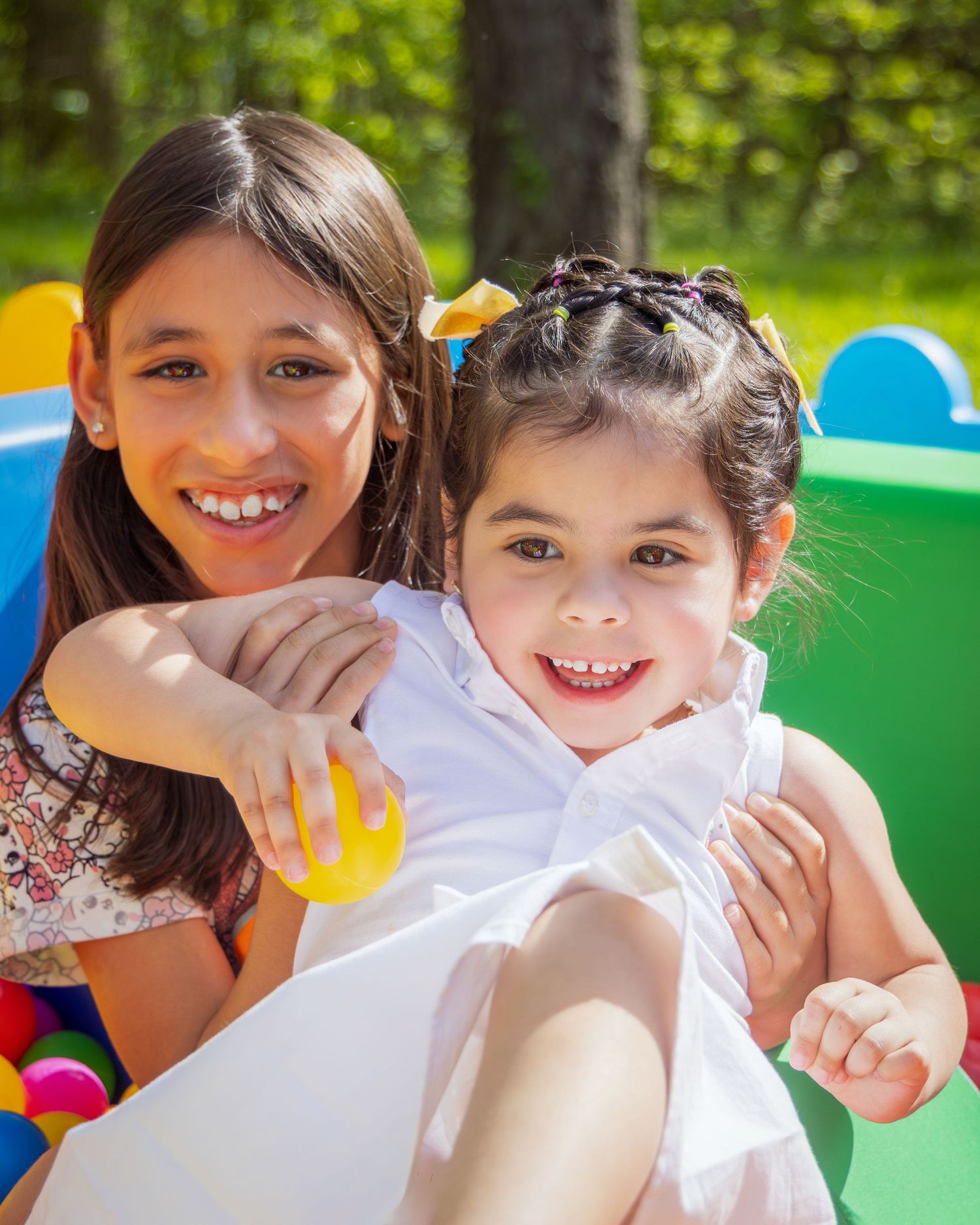 Children playing together and having fun at a summer camp in the park.